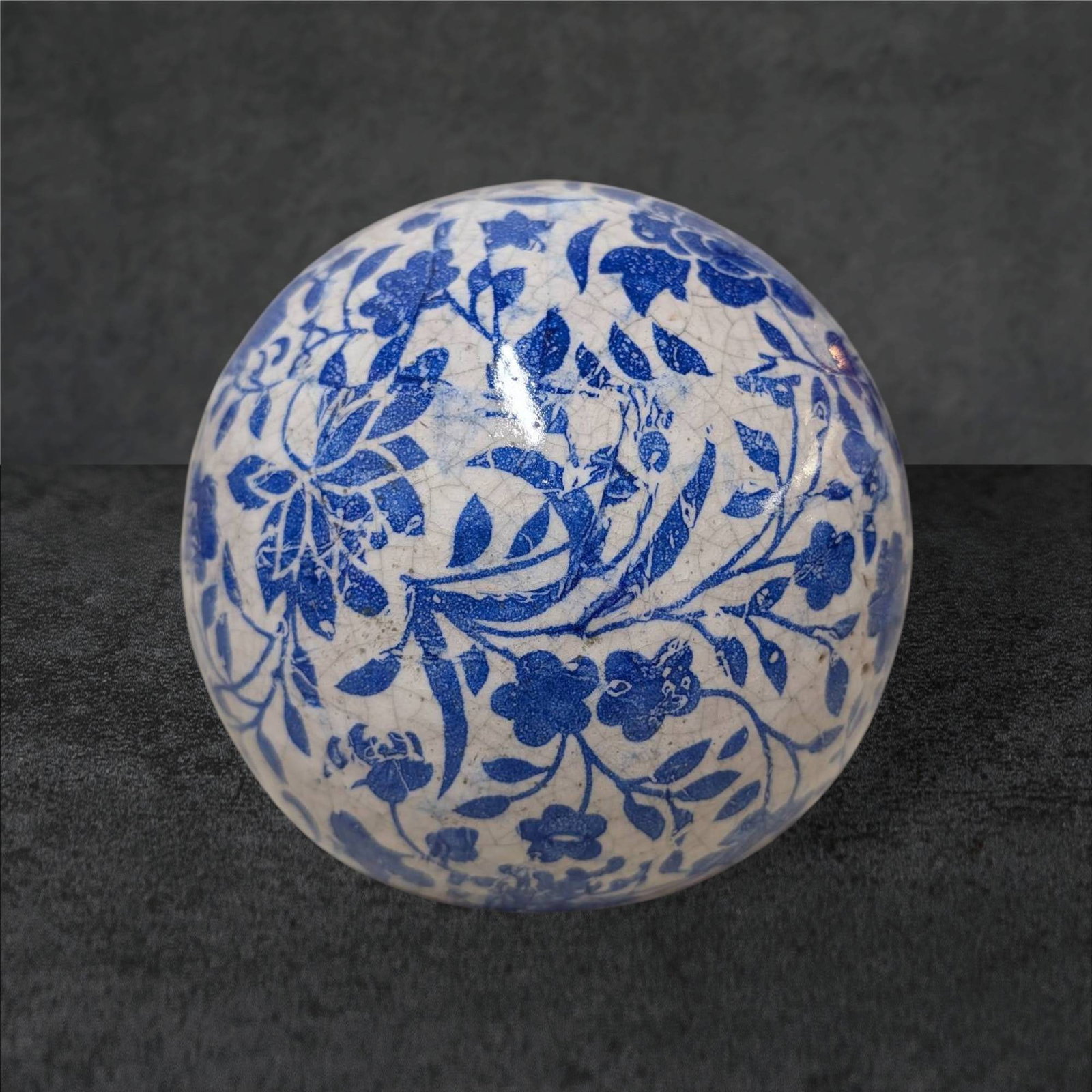 Blue and White Floral Decorative Porcelain Ball, Approx. 5 in Diameter: Traditional decorative porcelain ball featuring intricate blue floral motifs against a glazed white background. Often referred to as a carpet ball or Chinoiserie accent piece. Approximately 5 inches i
