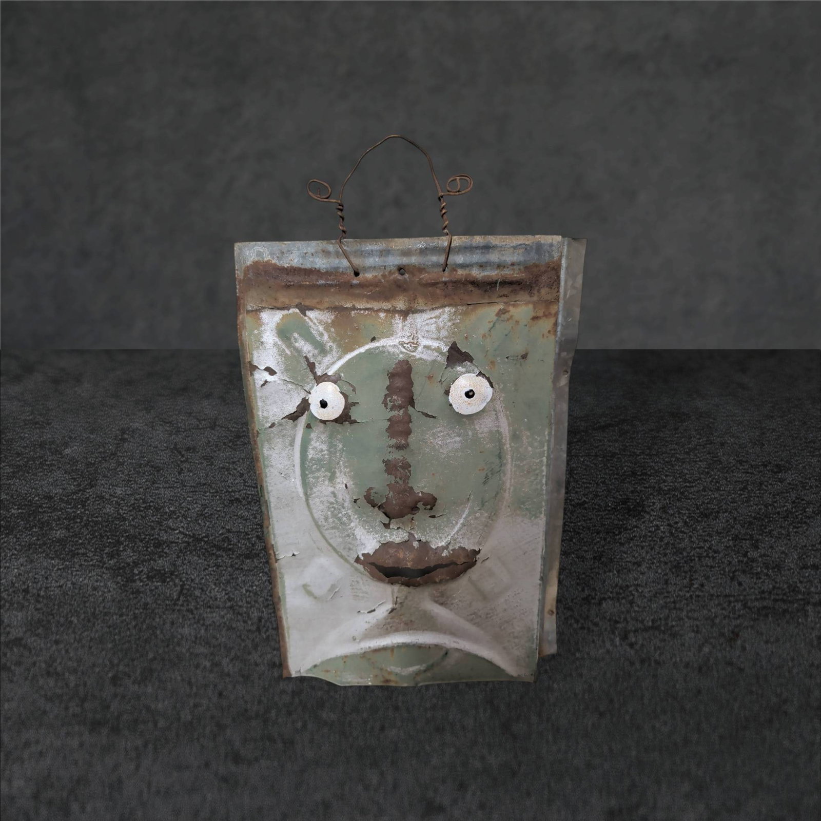 Signed Metal Wall Art Featuring Abstract Face Motif: Handmade metal wall art measuring approximately 14 in. x 9.5 in., featuring an abstract, dimensional face motif. Crafted from repurposed or galvanized metal with prominent texture, painted accents, an
