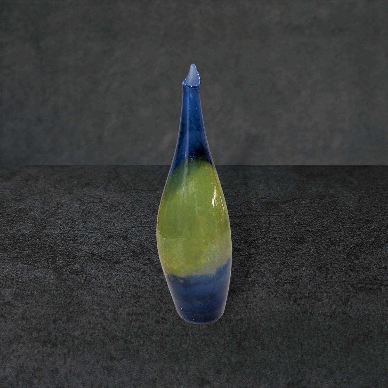 Handblown Glass Vase with Blue and Green Tones, 8.5 Inches Tall: Handblown glass vase featuring a tapered form with a pointed tip. The vase showcases vibrant blue and green tones blending seamlessly. Standing approximately 8.5 inches tall, the glass presents a smoo