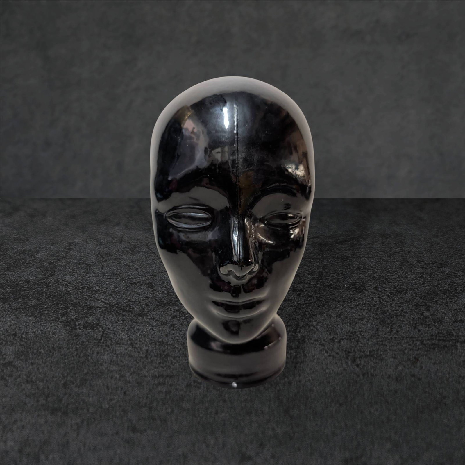 Black Amethyst Glass Head Sculpture, 11 in Tall: A glass head sculpture crafted from black amethyst glass. Measuring 11 inches tall, 8 inches wide, and 8 inches deep, this piece features a hollow interior and a smooth, glossy finish. Details include
