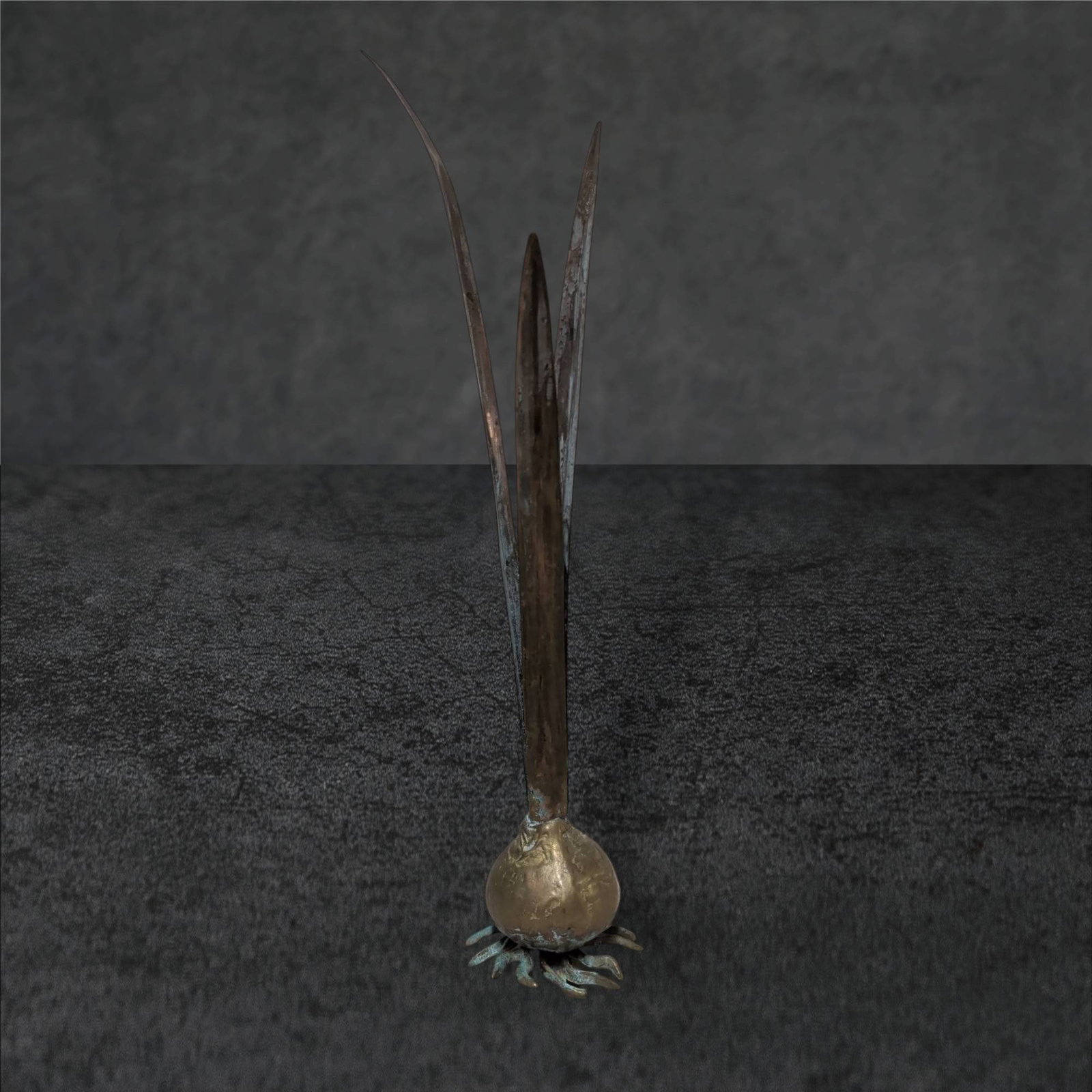 Metal Bulb Bud Vase, 13 in Tall: Metal bud vase styled as a bulb with emerging leaves, measuring 13 inches in height. The bulb base appears textured with a dual-tone finish, featuring a patina-accented surface and metallic leaves ext