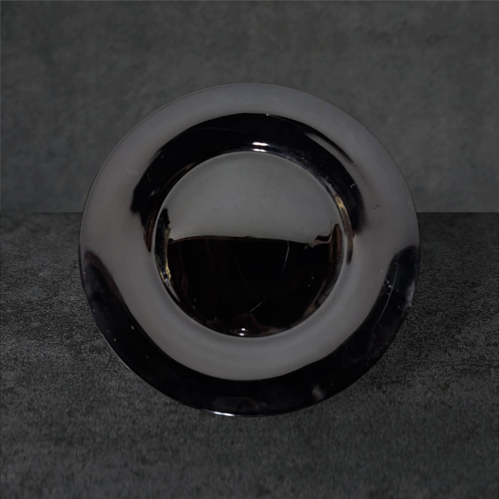Large Black Amethyst Glass Charger Plate, 12 1/2 in. Diameter: Black amethyst glass charger plate with a large flat surface and subtly raised rim. Measuring approximately 12 1/2 inches in diameter, the glass features a deep black surface with amethyst undertones 