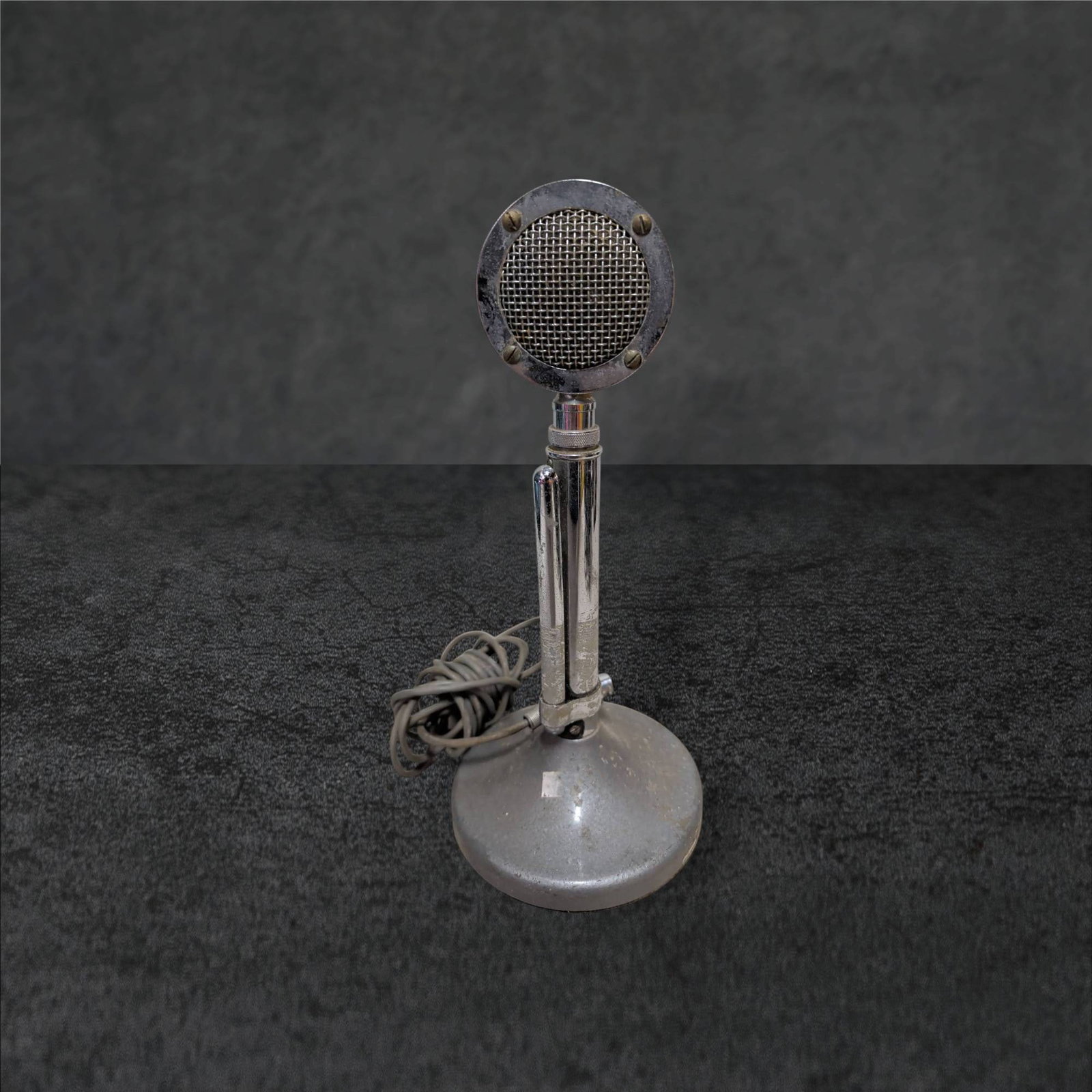 Chrome and Metal Vintage-Style Desktop Microphone, 12.5 Inches Tall: A desktop microphone measuring 12.5 inches in height with a chrome and metal construction. The piece features a circular mesh grille at the top and a weighted metal base for stability. Accompanied by 