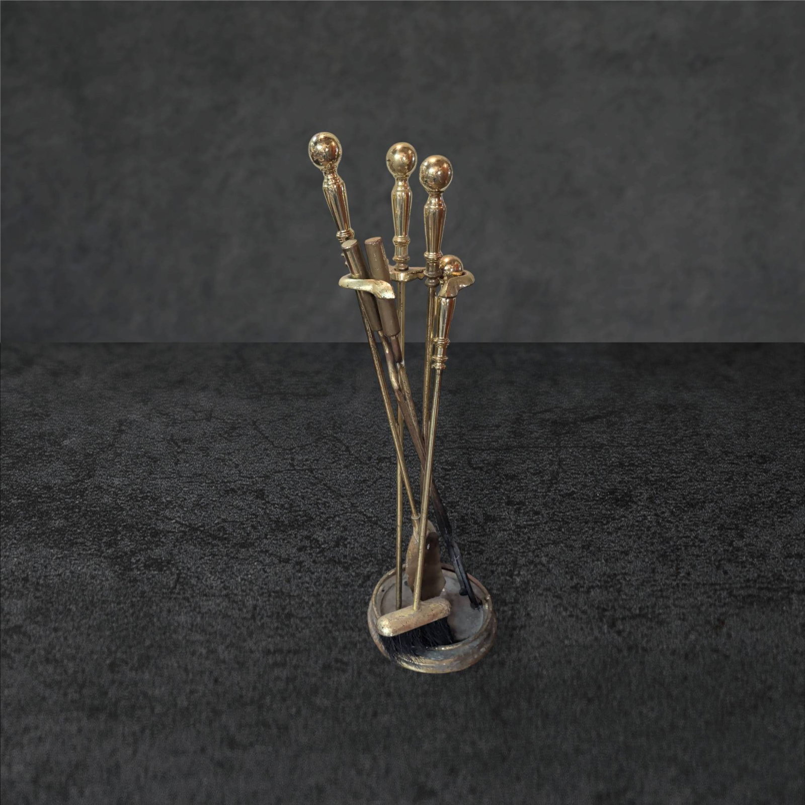 Brass Fireplace Tool Set with Stand, 31 in Tall: Four-piece brass fireplace tool set consisting of a poker, tongs, brush, and shovel, accompanied by a matching round stand. Tools feature decorative handles and are designed for functional use. The se