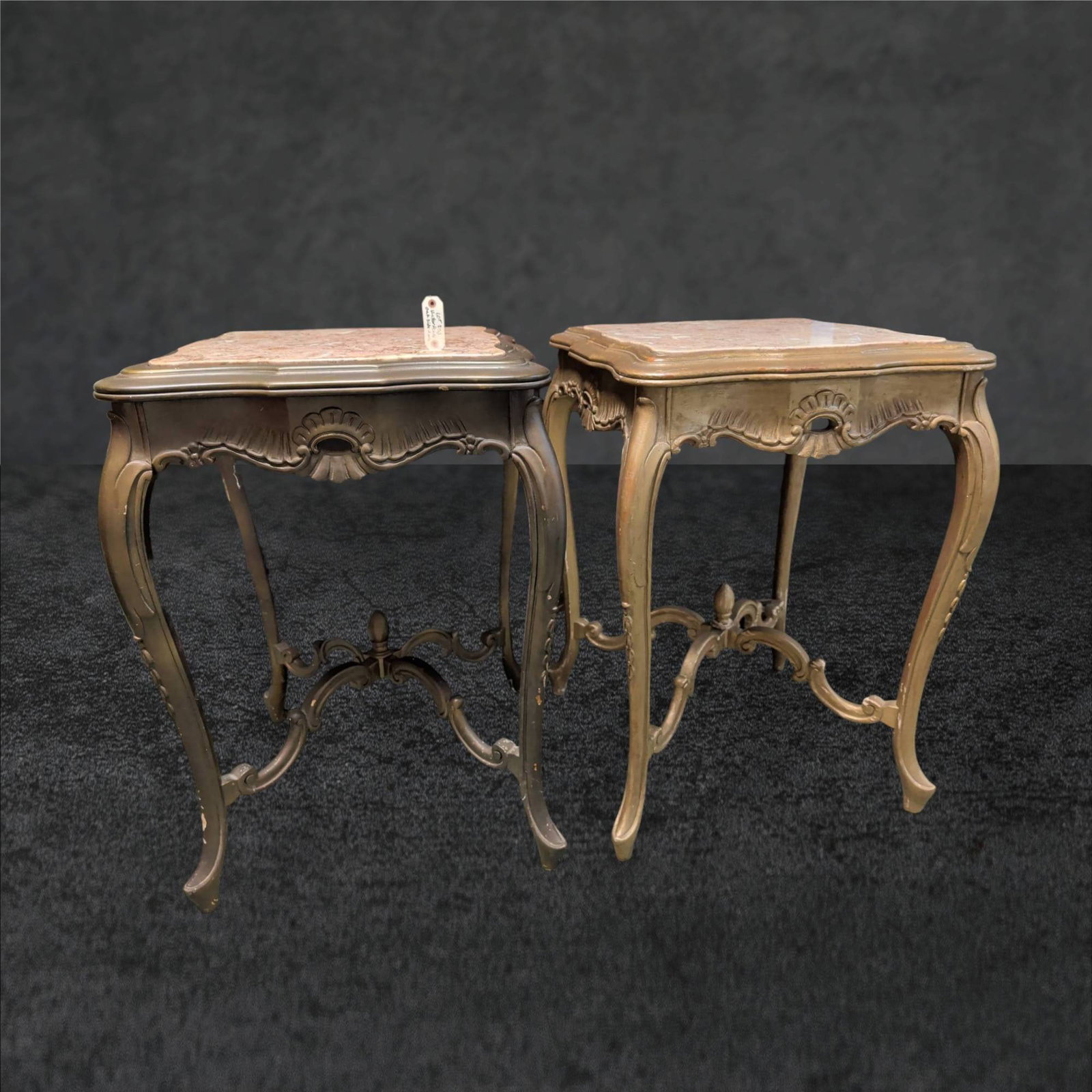 French Louis XV Style Gilt & Marble-Top Tables, 21 in. x 21 in. x 30 in.: French Louis XV-style giltwood tables with square pink marble tops. Features intricately carved aprons and cabriole legs connected by an ornamental stretcher with scrolled details. Marble tops exhibit