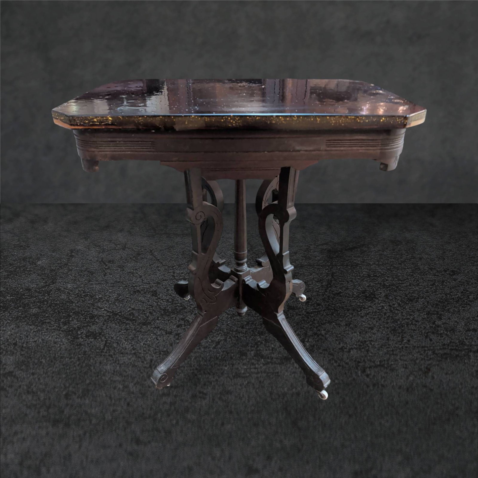 Victorian Era Table with Slide Glass Top, Amber Finish: Victorian-era table featuring a slide glass top with an amber finish. The table measures approximately 28.5 in. x 20.5 in. x 30.5 in. Supported by an intricately designed wooden base, it rests on four