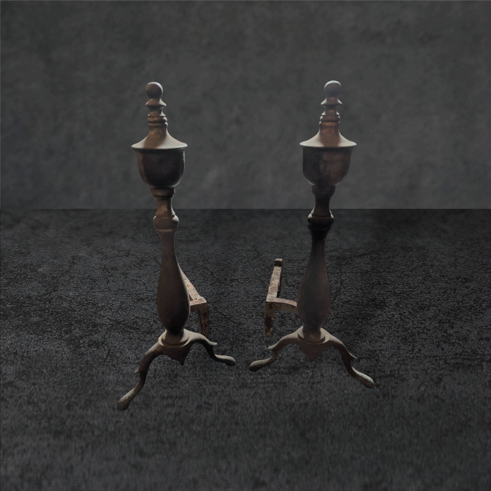 Cast Iron Acorn Andirons, 17 in Tall: Cast iron andirons featuring acorn finial tops and elegantly shaped shafts. Each measures 17 inches in height, 8 inches in width, and 12 inches in depth. The andirons rest on tripod bases with arched 