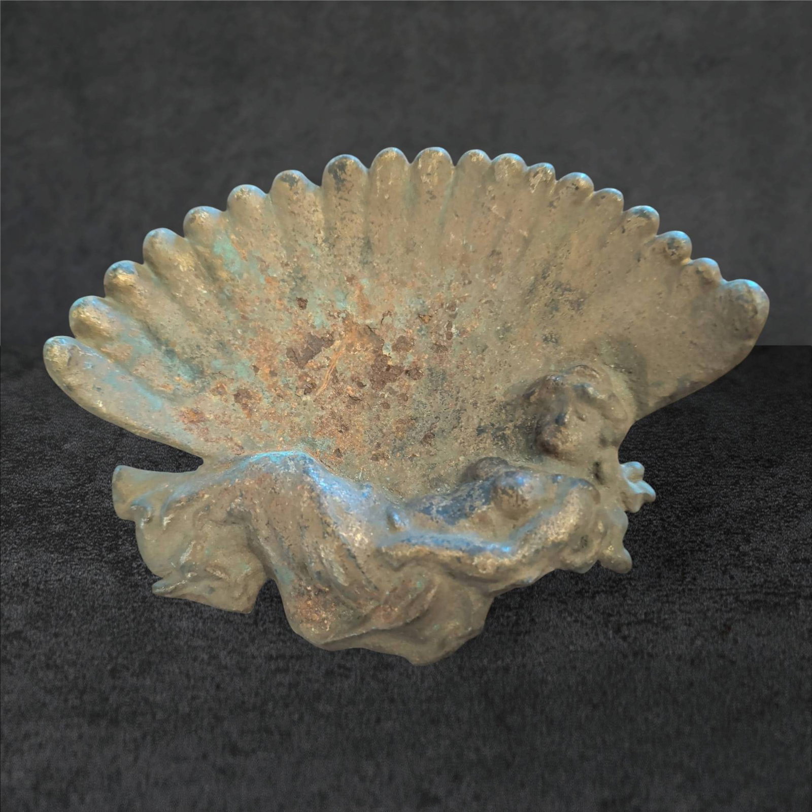 Victorian Cast Metal Calling Card Dish Featuring Reclining Figure and Shell Motif: Victorian-era calling card dish crafted from cast metal. Measures approximately 6 1/2 inches by 5 inches. Features a reclining figure at the base set against an intricately detailed shell motif backdr