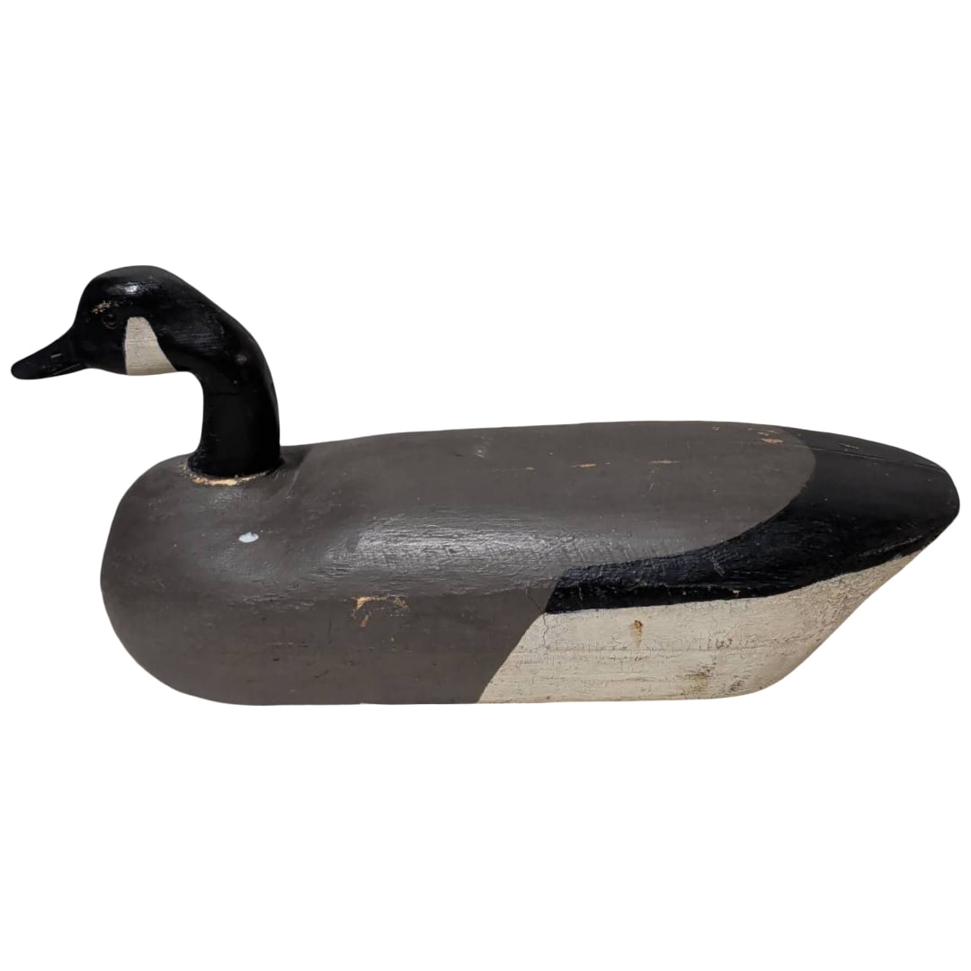 Hand-Carved and Painted Canada Goose by Gilbert, Trenton, New Jersey: Hand-carved wooden depiction of a Canada goose, made by artisan Gilbert of Trenton, New Jersey. The sculpture measures 10 inches tall and 7 inches wide, featuring detailed hand-painted black, gray,
