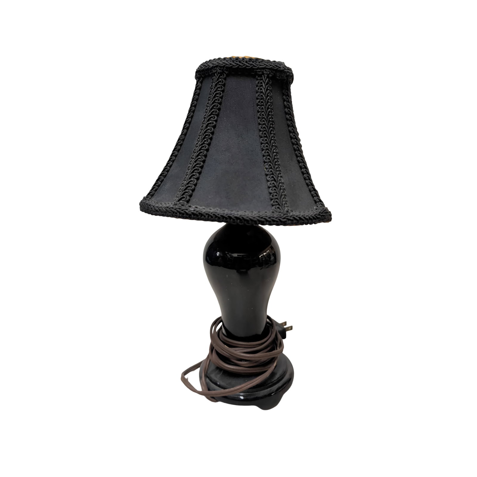 Amethyst Glass Table Lamp with Shade, 12 Inches Tall: Table lamp with a base made of amethyst glass, measuring 10 inches tall (12 inches including the shade). Includes a black fabric shade with braided trim. Detachable shade and visible wiring. Normal