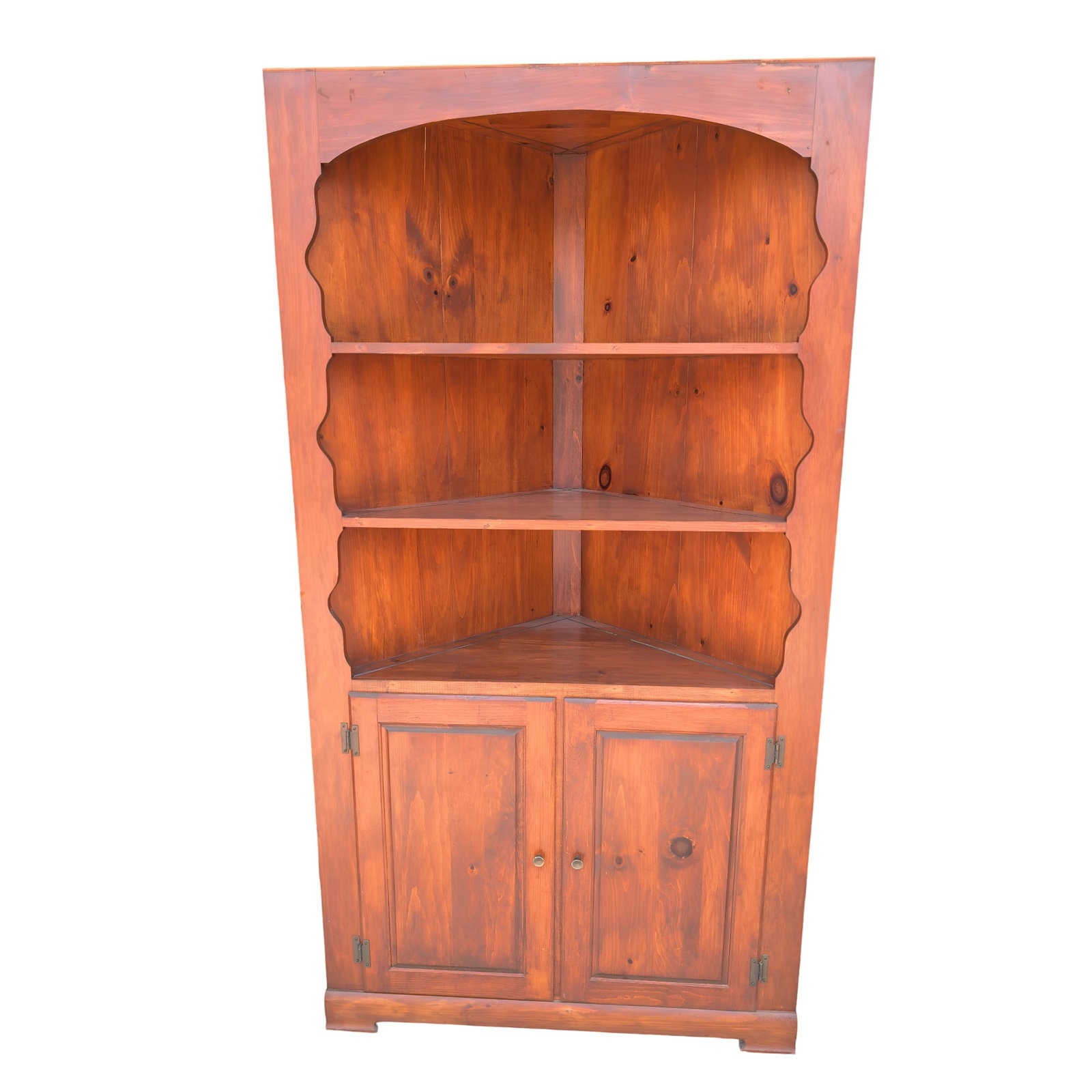 Vintage 1976 Corner Cabinet With Two Shelves and Double Doors: Wooden corner cabinet measuring 71.5 inches tall, 25.5 inches wide, and 38 inches deep. Made in 1976, it features two upper open shelves and a lower enclosed storage space with double doors. Handwriti
