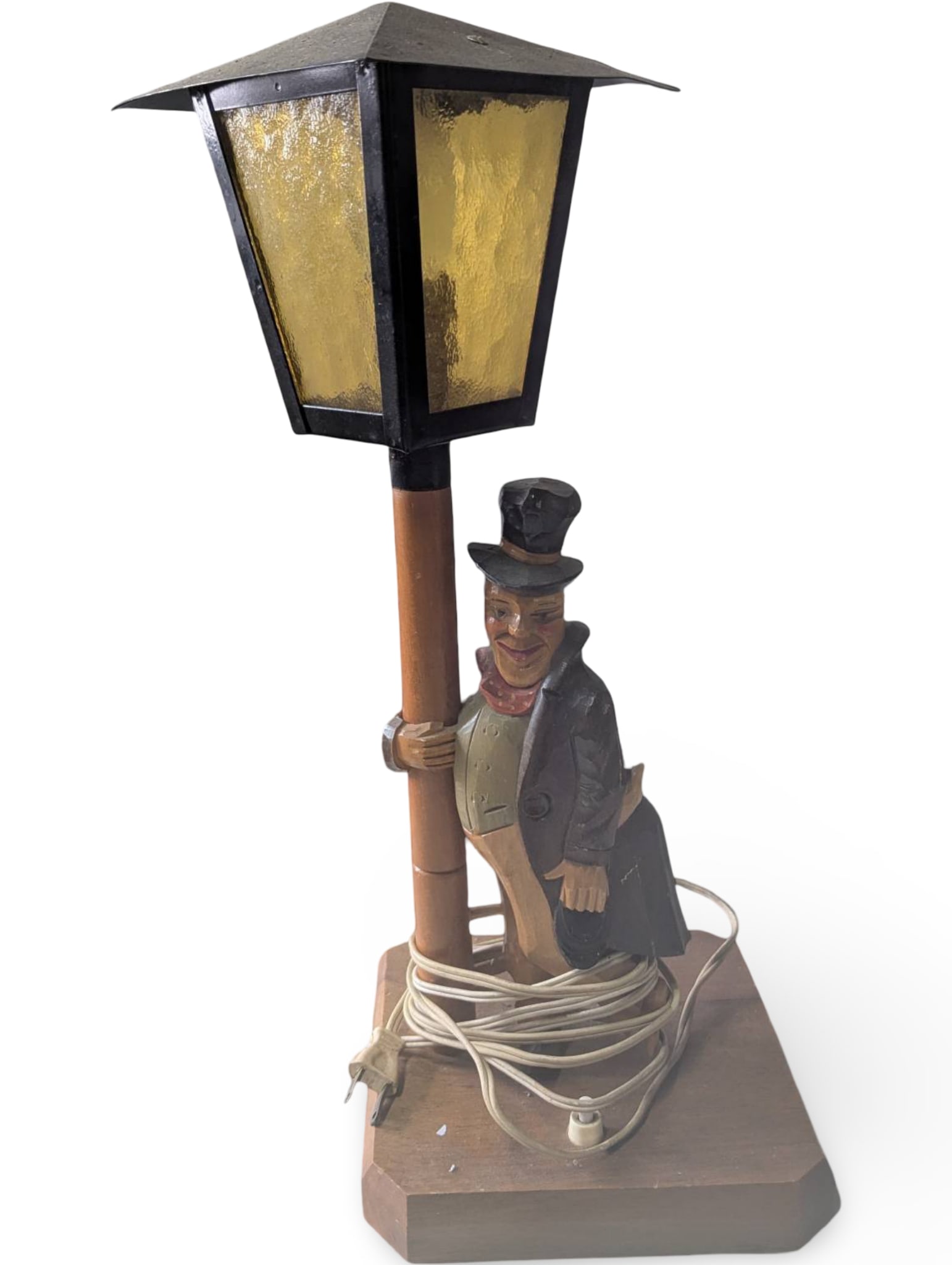 Black Forest Wood-Carved Music Box with Drunken Man and Lamppost: Black Forest wood-carved music box depicting a drunken man leaning on a lamppost. The lamp features a functional light with a yellow stained-glass-style shade. The base, measuring 7 in by 7 in, houses
