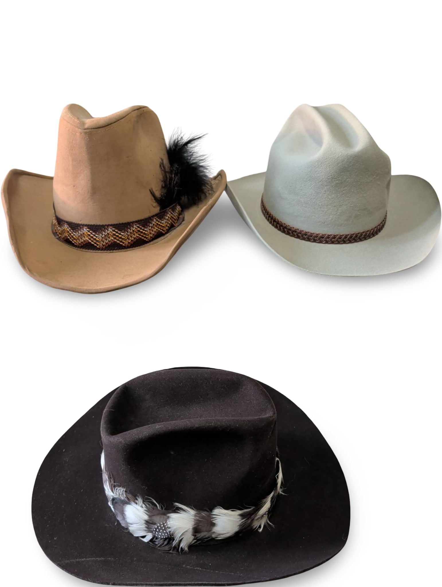 Three Western Cowboy Hats, Including Dynafelt and 5X Beaver Models: Three western-style cowboy hats featuring different materials and embellishments. One tan hat with feather and patterned woven band, interior labeled 'Dynafelt'; one light gray hat with a similar wove