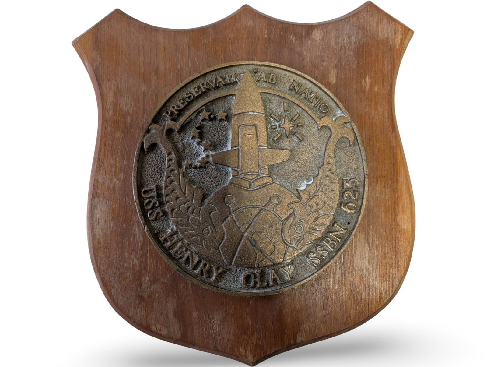 Bronze USS Henry Clay SSBN 62 Submarine Placard on Wooden Shield Mount: Bronze commemorative placard for the USS Henry Clay (SSBN 62) submarine, mounted on a shield-shaped wooden plaque. The bronze placard measures approximately 11 inches by 10 inches and depicts detailed