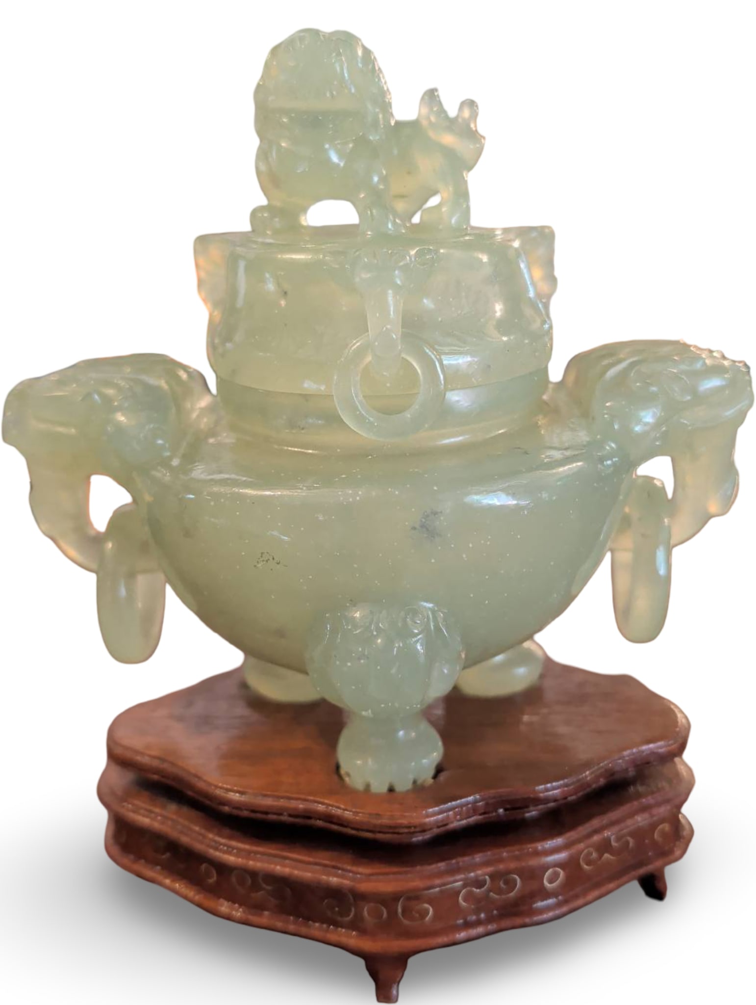 Carved Jade Censer with Lid, Handles, and Wood Stand: A carved jade censer measuring 6 1/2 in tall, 6 in wide, and 4 in deep. Features a detachable lid adorned with a carved finial and two ring handles. The body is supported by three sculpted feet and in