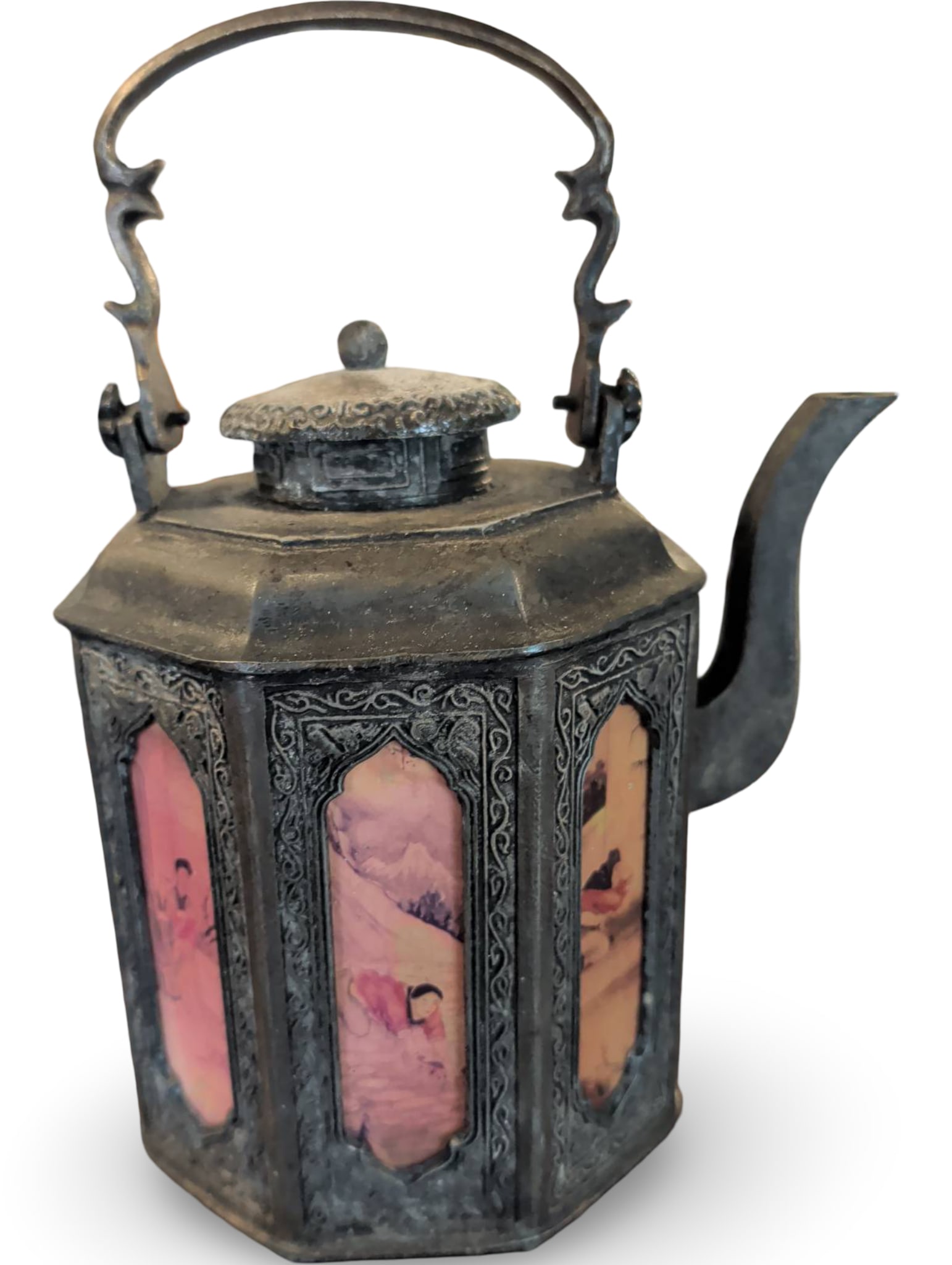 Hexagonal Metal Teapot with Painted Glass Panels and Hinged Lid: Hexagonal metal teapot measuring 8 inches tall, 6 inches wide, and 4 inches in diameter. Features painted glass panels with floral and landscape scenes, decorative metal framing, a hinged lid, and an 