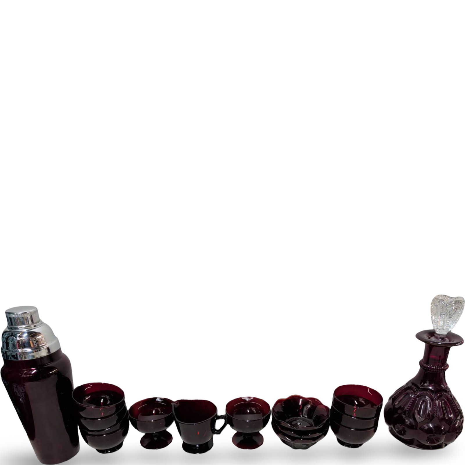Ruby Red Glass Collection Including Decanter, Shaker, and Bowls: Ruby red glass collection comprising a decanter with a height of 11.5 inches, featuring an ornate stopper, and a matching shaker measuring 12 inches tall with a chrome lid. The set also includes bowls