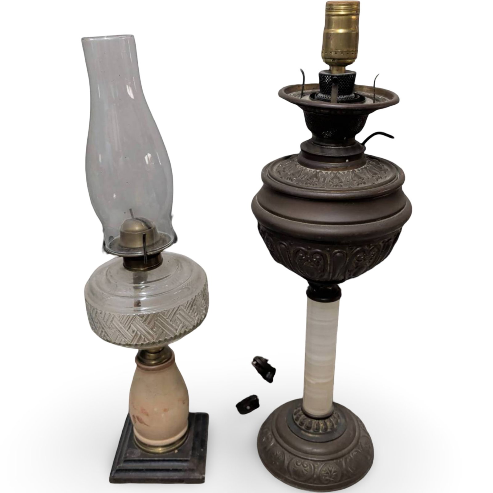 Oil Lamps, Including Modernized Banquet Lamp and Glass Chimney Lamp: Two antique oil lamps comprising of a 22-inch modernized banquet or piano lamp featuring ornate cast metal details, a columnar base, and electrical fittings. The second lamp includes a glass chimney, 