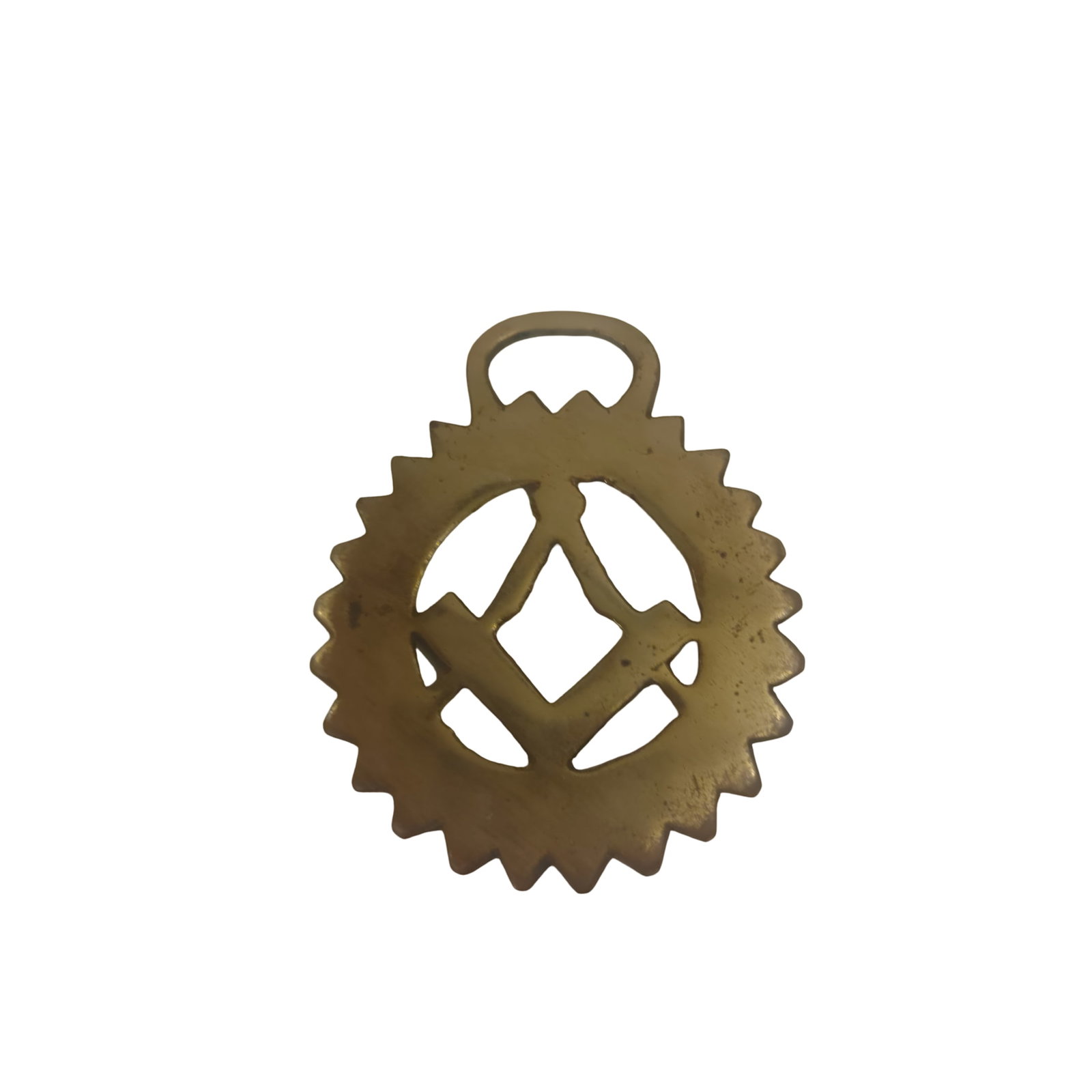 Vintage Brass Masonic Horse Brass Featuring Compass and Square Design: A vintage brass horse brass depicting a Masonic compass and square design, emblematic of Freemasonry. The brass features a toothed edge oval shape with an integrated handle for attachment. The front