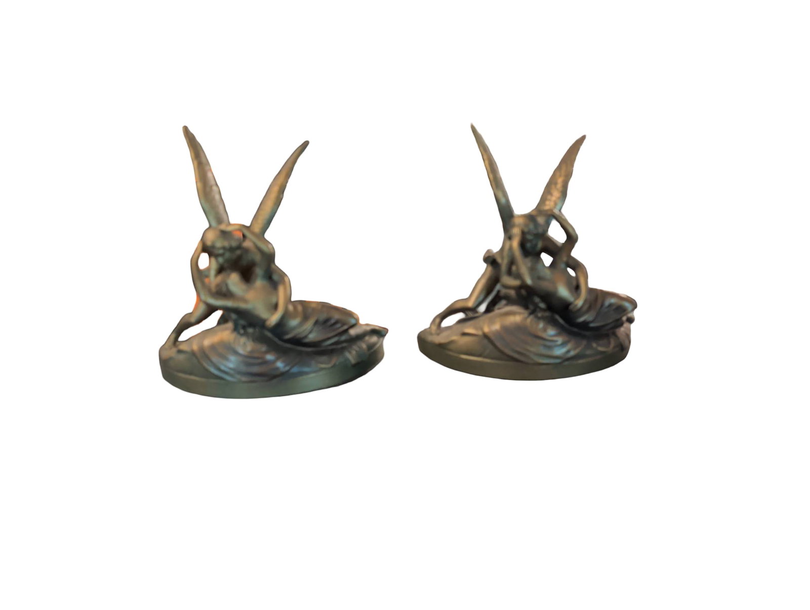 Bronze-Finish â€˜Cupid and Psycheâ€™ Bookends on Black Marble Base: Bookends depicting the mythological scene 'Cupid and Psyche,' inspired by Antonio Canova's neoclassical sculpture. Crafted from cold-cast resin with a metallic bronze finish, each piece rests on a bla
