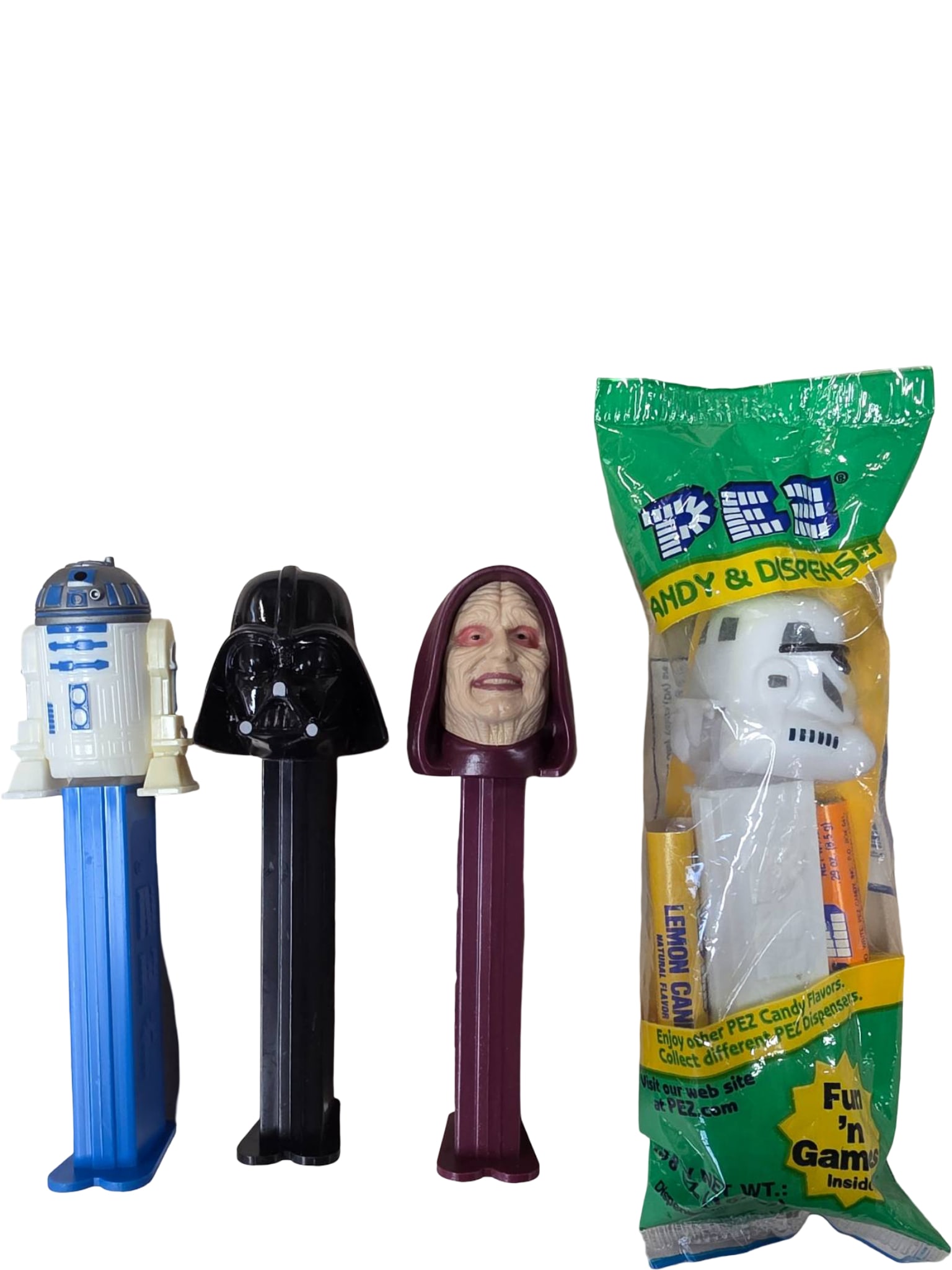 Star Wars-Themed PEZ Dispensers Including R2-D2, Darth Vader, Emperor Palpatine, and Stormtrooper: Four PEZ dispensers featuring characters from the Star Wars franchise: R2-D2, Darth Vader, Emperor Palpatine, and a Stormtrooper. Three dispensers are unwrapped, while the Stormtrooper dispenser is se