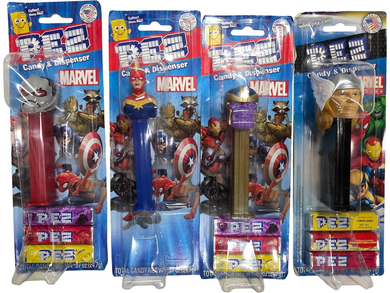 Four Marvel-Themed Pez Candy Dispensers in Original Packaging: Four Marvel-themed Pez candy dispensers, each in its original sealed packaging. The set features characters including Captain Marvel, Thanos, Ant-Man, and Thor, with graphics and licensed branding.