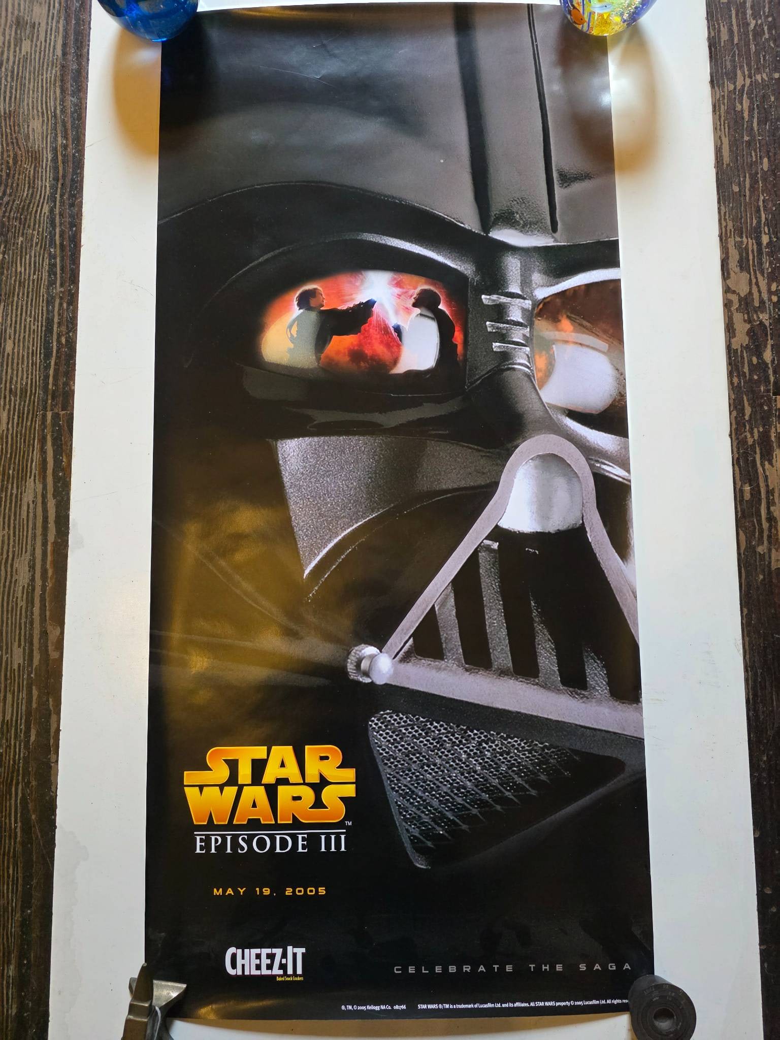 Star Wars: Episode III Promotional Poster with Cheez-It Branding, 2005: Star Wars: Episode III–Revenge of the Sith promotional poster featuring Darth Vader’s mask and imagery from the film. Includes release date (May 19, 2005) and branding for Cheez-It promotion.