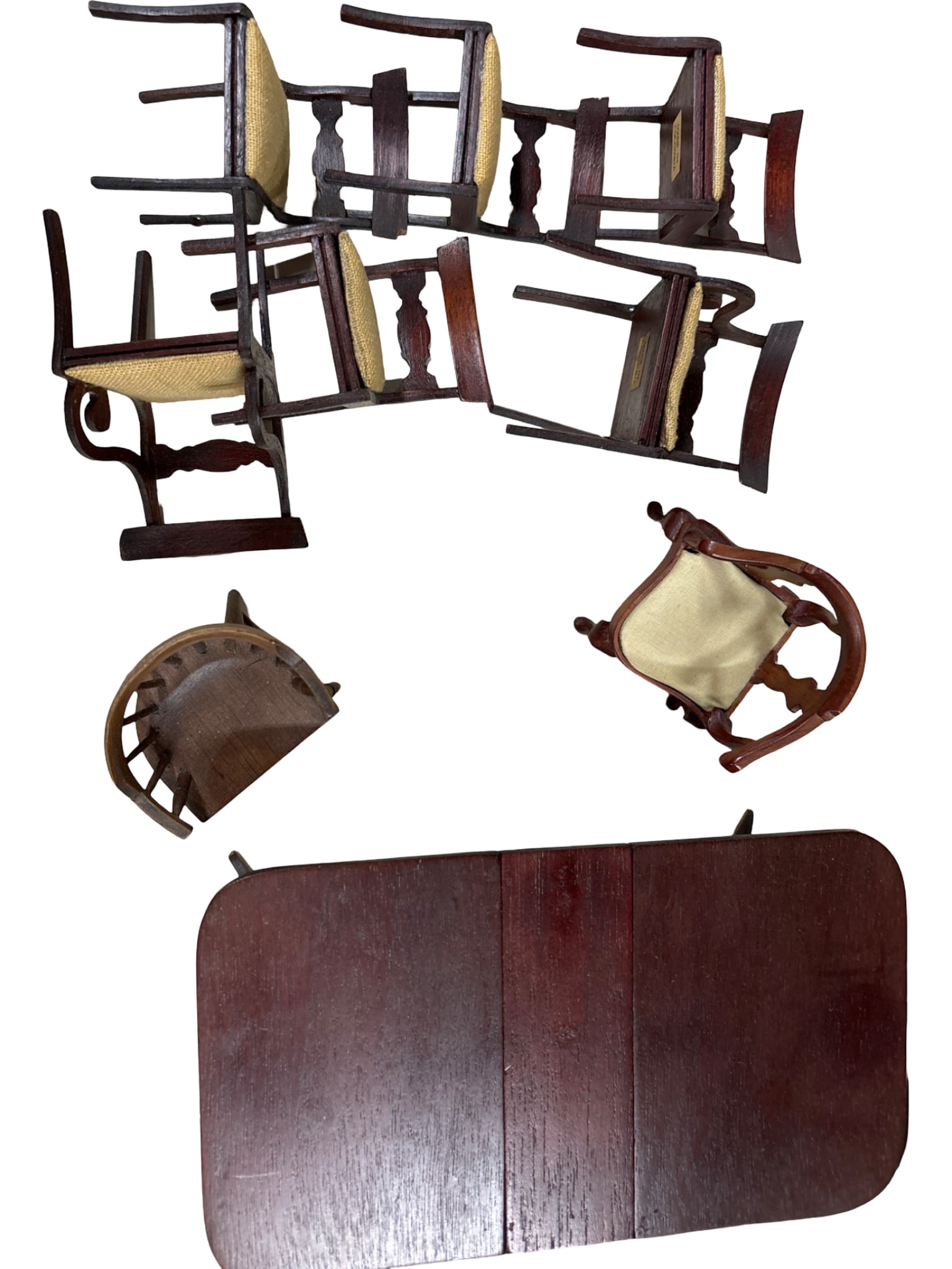 Miniature Wooden Furniture, Including Chairs and Table, Made in Colombia: Miniature furniture including a table, six wooden chairs with woven seats, and two additional armchairs. Each piece features wood construction, with some marked “Made in Colombia.” The chairs 