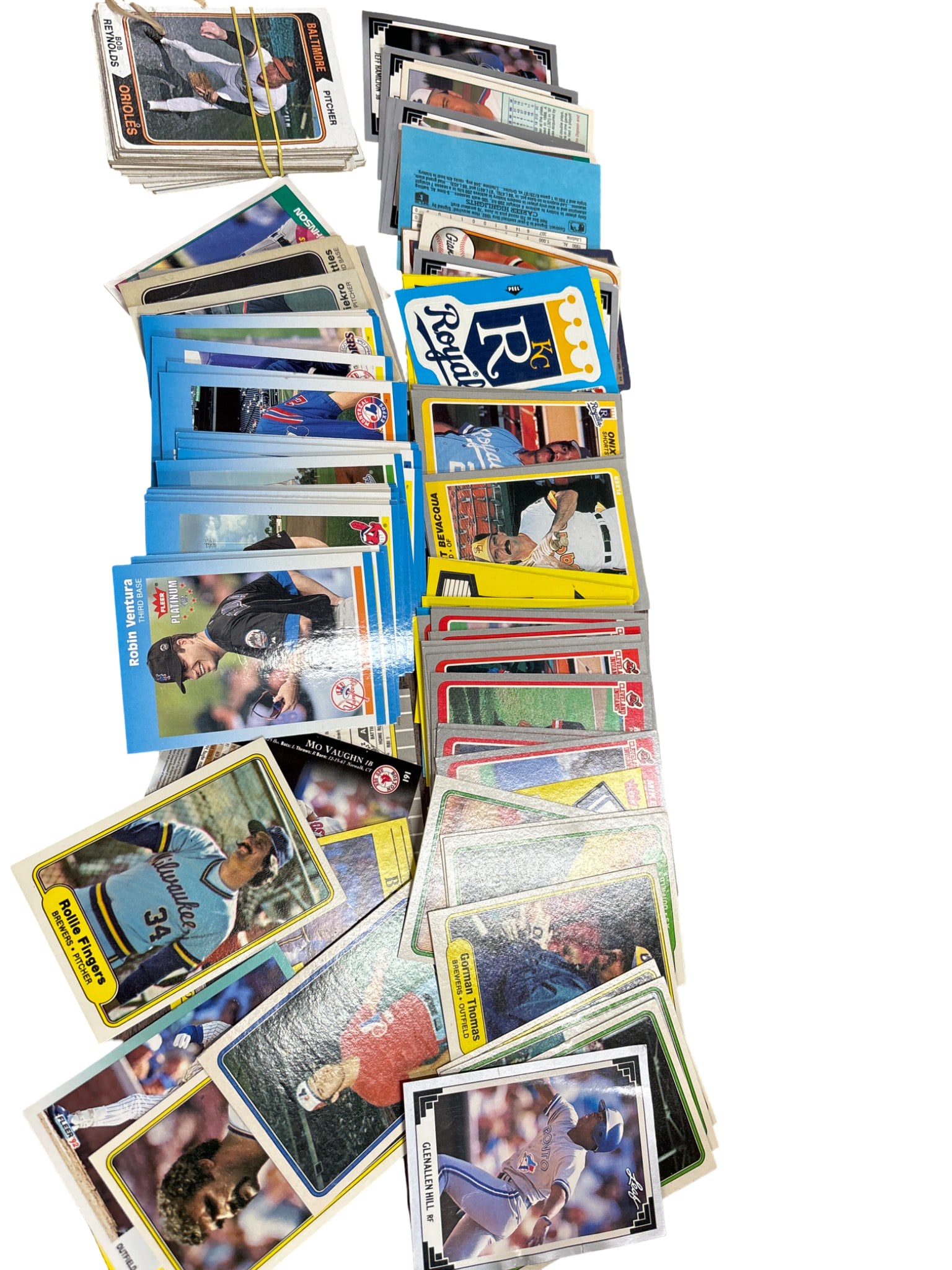 Baseball Trading Cards Featuring Various Teams and Players: Vintage and modern baseball trading cards featuring a variety of players, teams, and brands. Includes cards from brands such as Topps, Donruss, and others. The collection appears to include player and