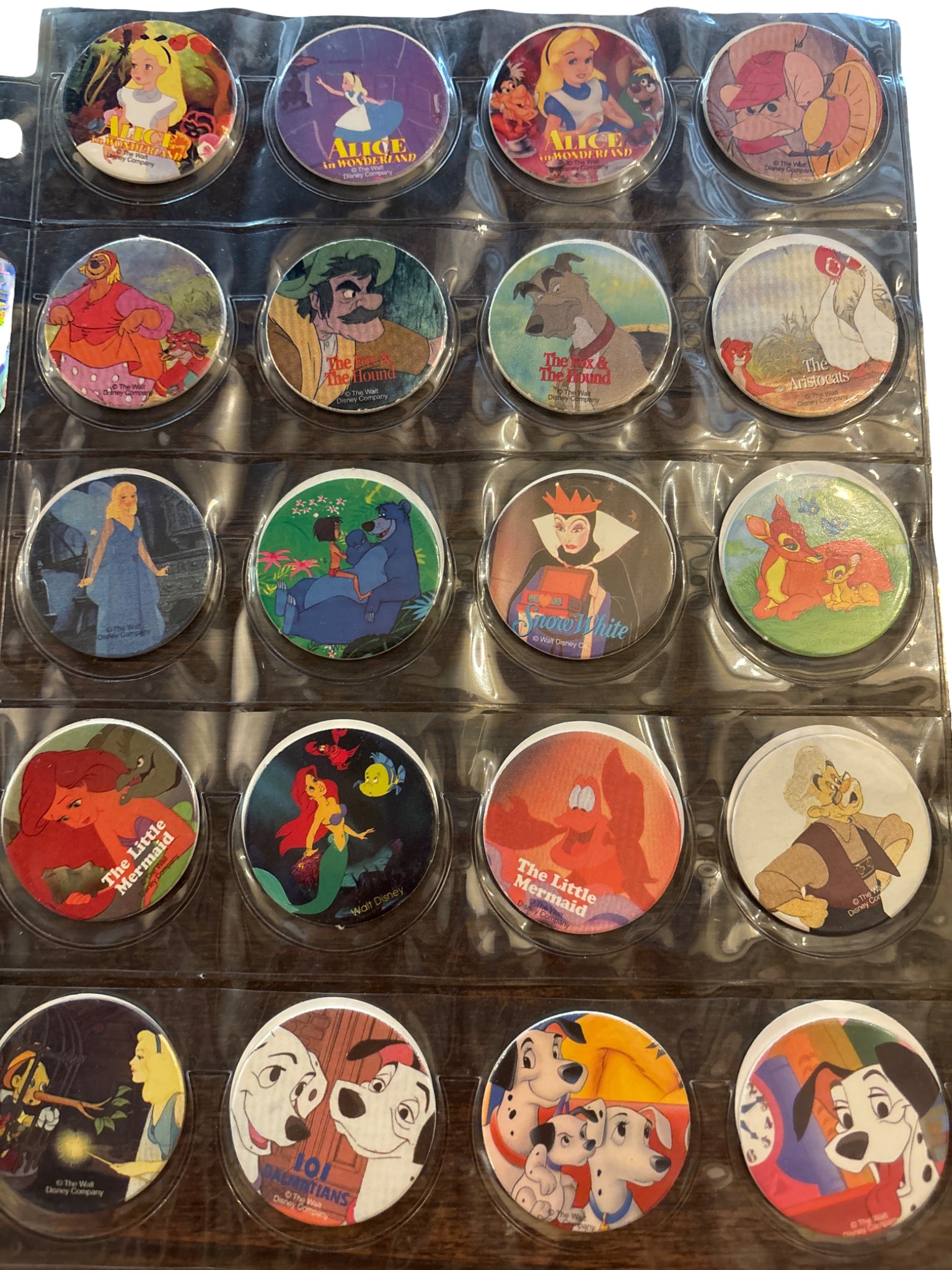 Complete Set of Pog 1-65 Featuring Disney Characters: A complete collection of Pogs numbered 1 through 65, featuring colorful designs of various Disney characters. Includes characters from classic films such as Aladdin, The Little Mermaid, Dumbo, and man