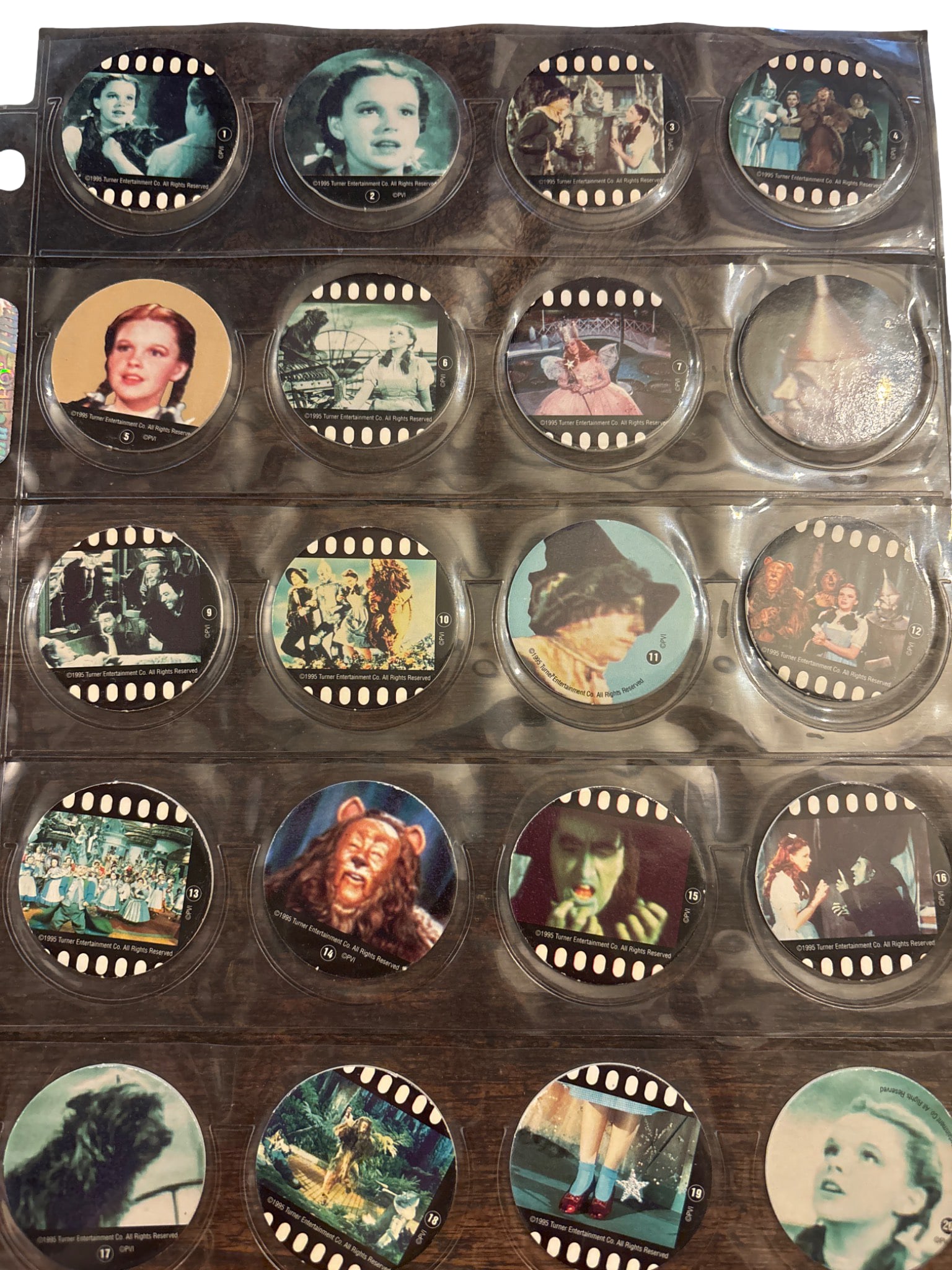 Complete Set of The Wizard of Oz Pogs, 1-50, Featuring Movie Scenes: Complete set of 50 Pogs from The Wizard of Oz series, numbered 1-50. Each Pog features a vibrant printed image of scenes and characters from the classic film, showcasing Dorothy, the Scarecrow, the Ti