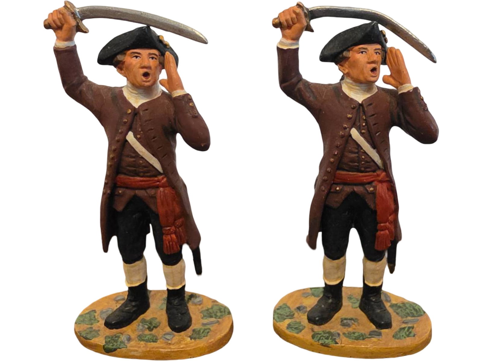 Two Hand-Painted Miltia Officers Metal Soldier Figurines: Two Metal figurines depicting colonial-era soldiers in uniform, each holding a raised sword. Features vibrant hand-painted details, including brown coats, black tricorn hats, red sashes, and