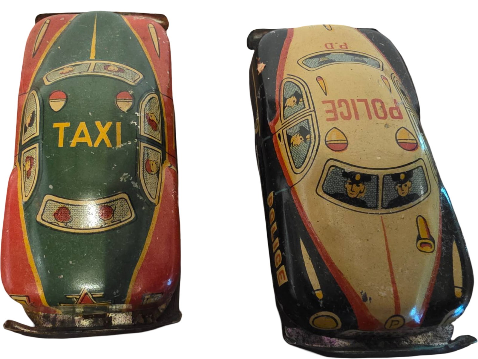 Two Vintage Tin Lithographed Friction Toy Cars: Taxi and Police Car: Two Tin lithographed friction toy cars featuring a taxi and a police car design. The taxi car is green and red with ‘TAXI’ marked on the roof and doors. The police car features a black and yellow