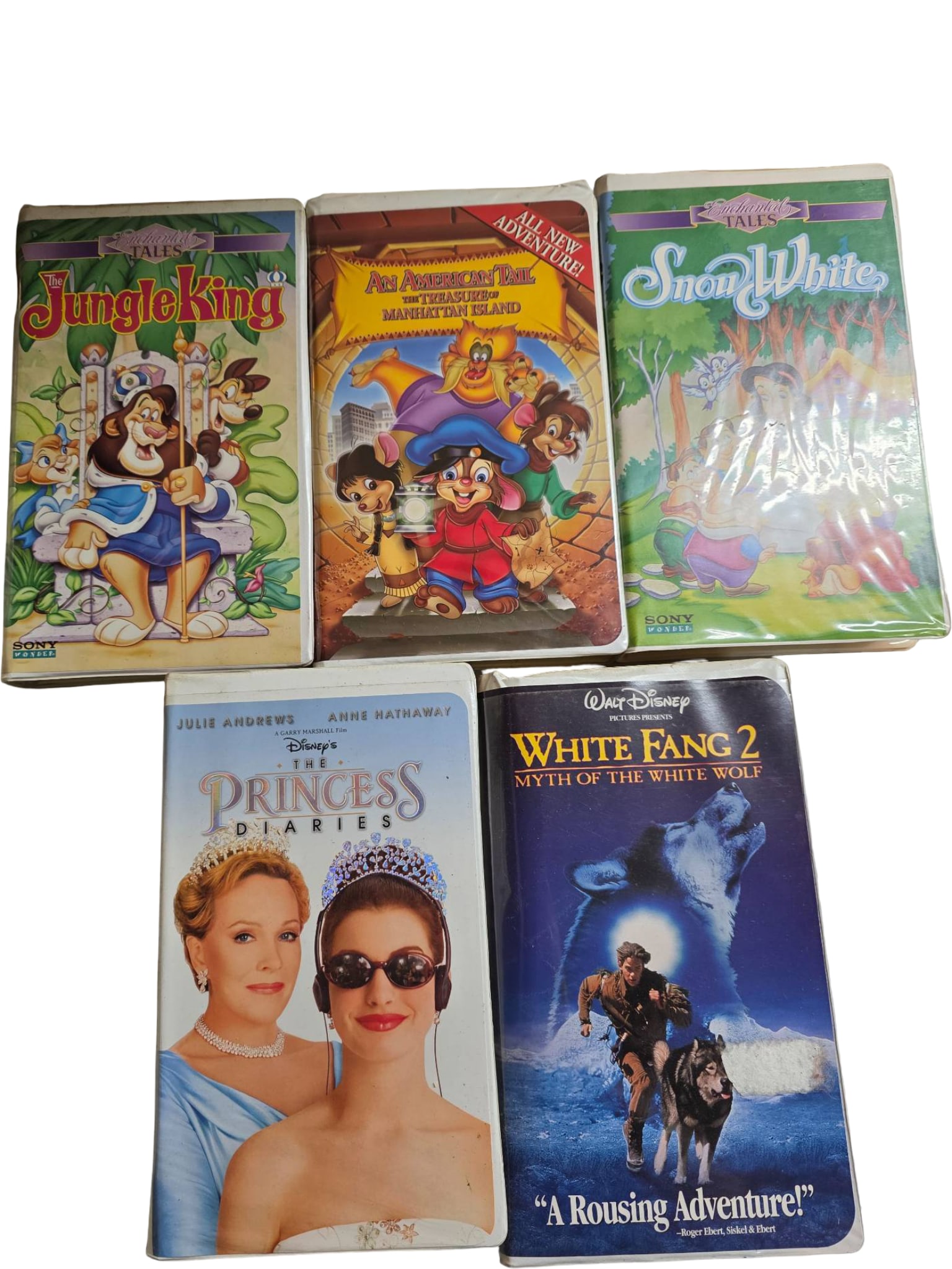 Five VHS Tapes Including Animated and Feature Films: Five VHS tapes: ‘Jungle King,’ ‘A Tale of Two Critters,’ ‘Snow White,’ ‘The Princess Diaries,’ and ‘White Fang 2: Myth of the White Wolf.’ Tapes’ outer cases show varying signs