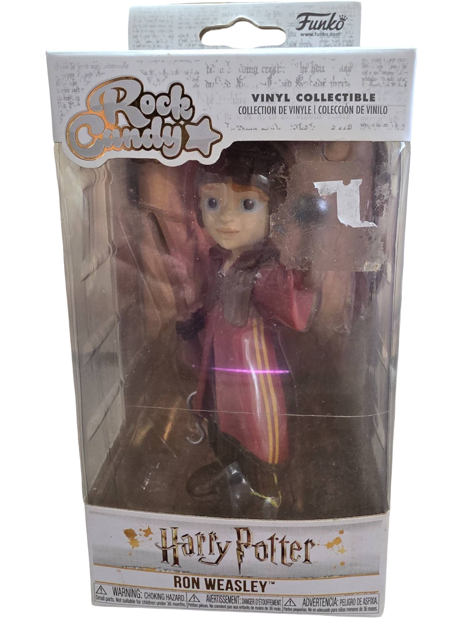 Funko Rock Candy Harry Potter Ron Weasley Vinyl Collectible, Boxed: Funko Rock Candy vinyl collectible figure featuring Ron Weasley from the Harry Potter series, wearing Quidditch robes. The figure is boxed in its original packaging with protective plastic casing.