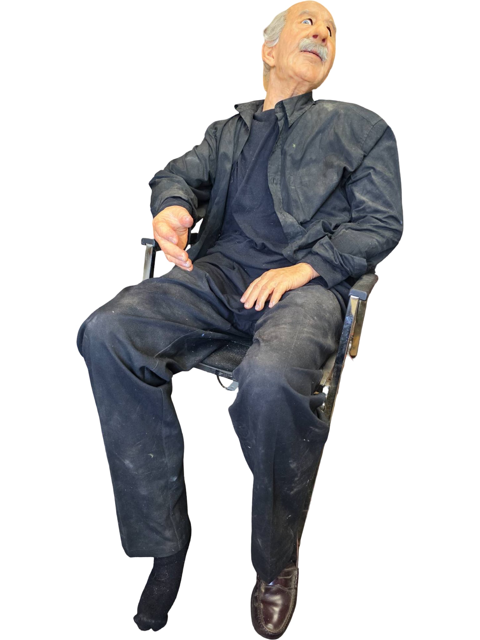 Animatronic Albert Einstein Model with Realistic Features: Animatronic model depicting Albert Einstein, featuring a lifelike sculpted face, detailed hair, and mustache. The model is dressed in a black outfit and seated in a chair. Wiring is visible, suggestin