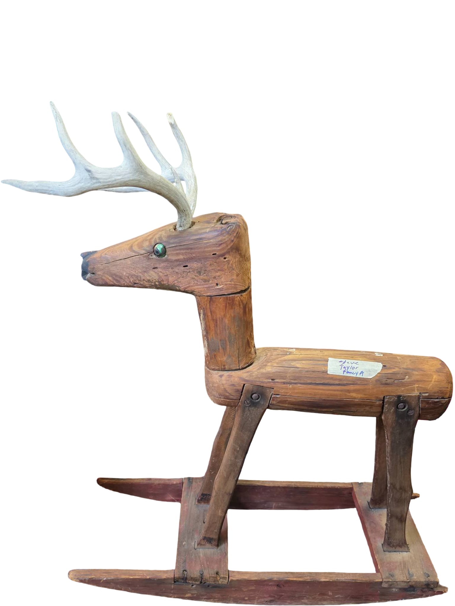 Wooden Rocking Deer Toy with Carved Antlers: Wooden rocking deer toy featuring hand-carved construction with attached antlers resembling deer antlers. Mounted on a rocker base, the piece exhibits a rustic and handcrafted aesthetic. Notable
