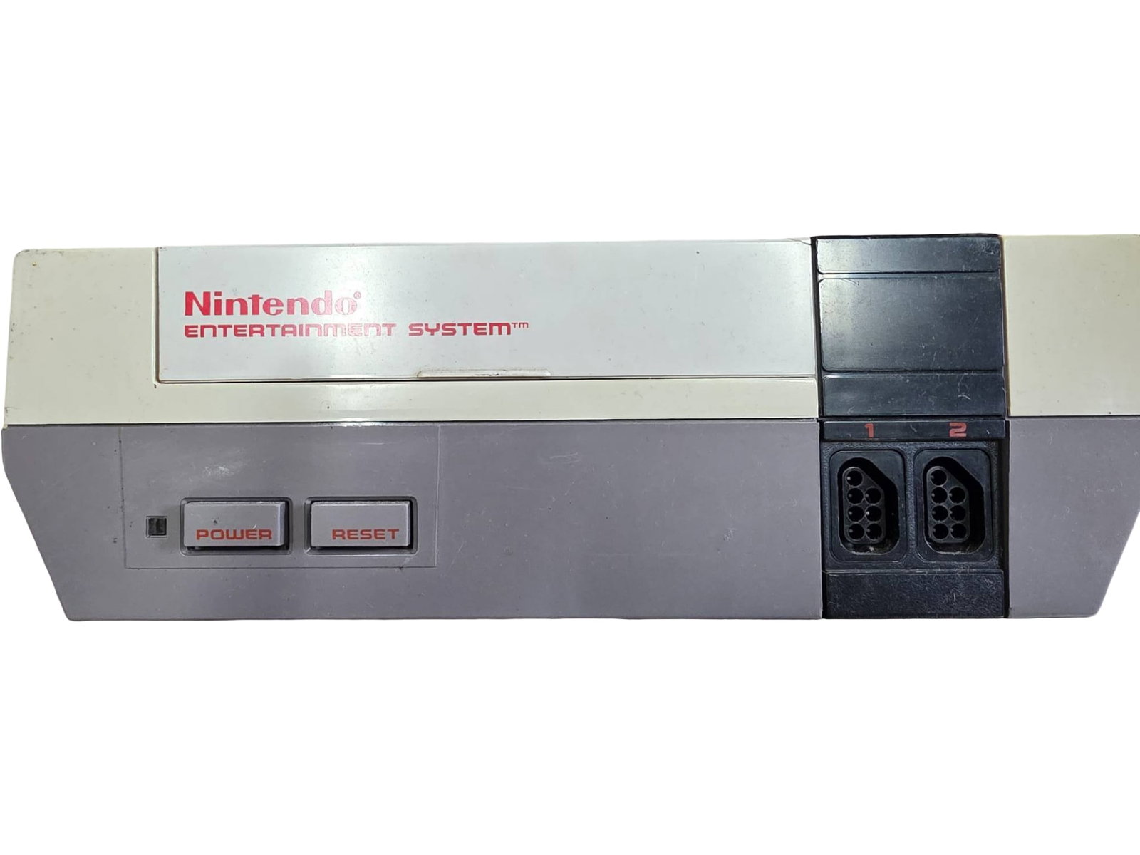 Nintendo Entertainment System (NES) Console with Custom Mario Artwork: Original Nintendo Entertainment System (NES) console. Features a custom Mario graphic on the top cover. Includes standard power/reset buttons and dual controller ports. Model details are visible on th