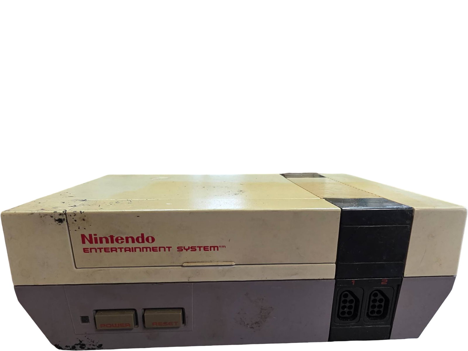 Nintendo Entertainment System (NES) Console – Original Front-Loading Model: Nintendo Entertainment System (NES) console featuring the original front-loading design. Includes visible wear, discoloration, and surface markings, with some paint chipping on the top shell and