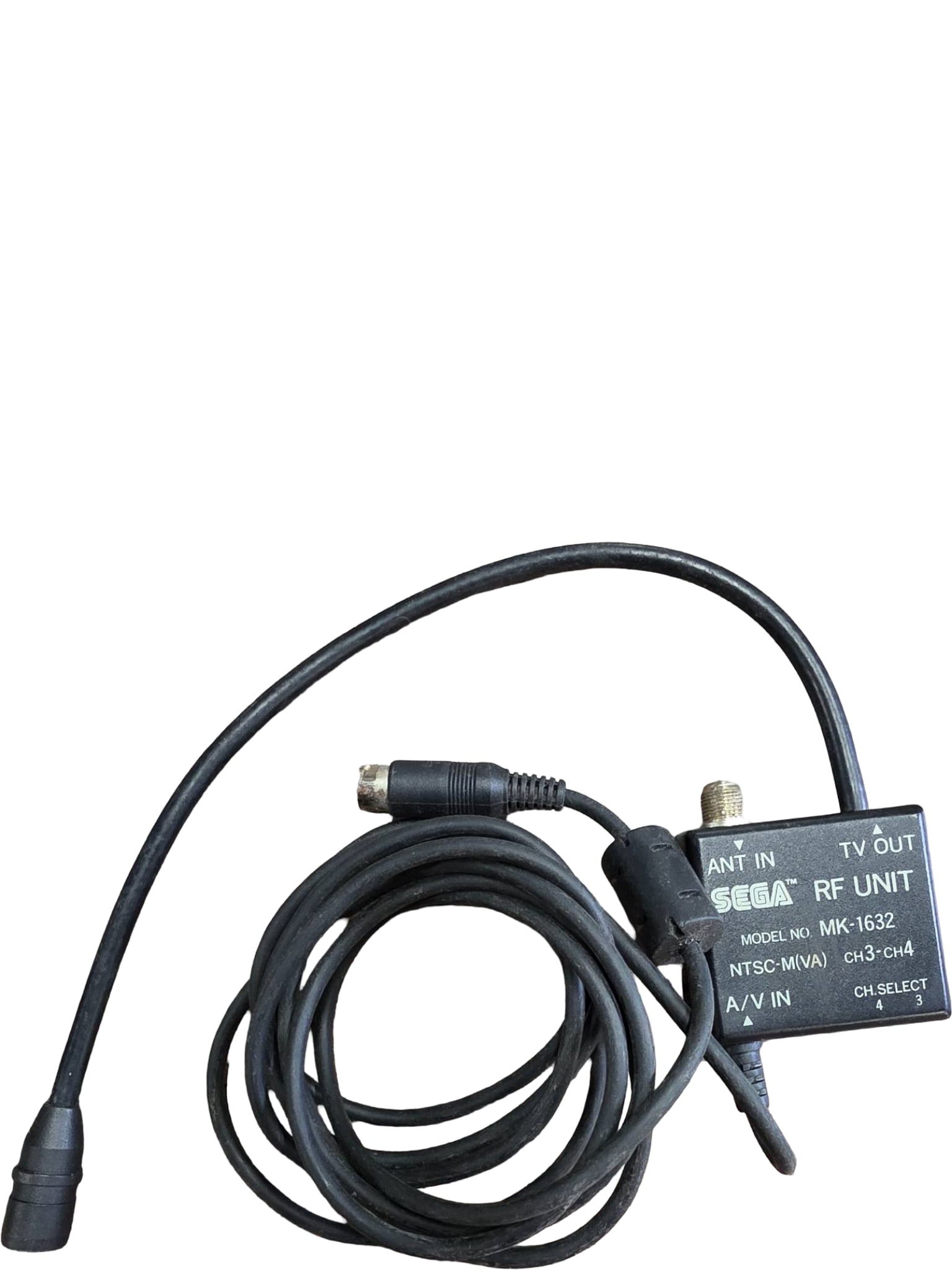 Sega RF Unit Model MK-1632 with Integrated Cable: Sega RF Unit Model MK-1632, compatible with NTSC-M(VA) systems. Features ANT IN and TV OUT connections and channel selector for CH3 or CH4. Includes integrated A/V cable. Designed for older Sega