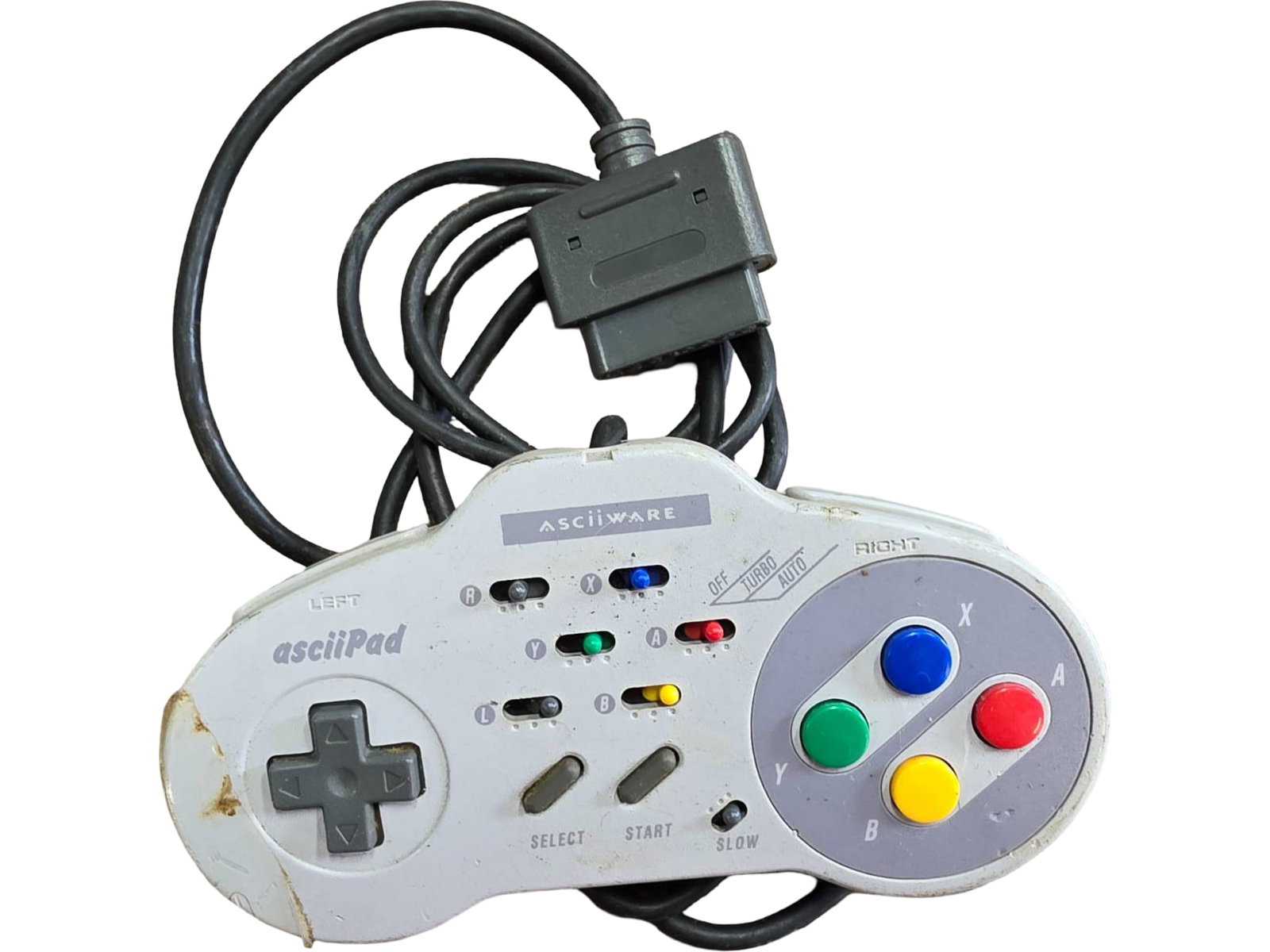 Asciiware Asciipad Controller for Super Nintendo, Model No. 4600: Asciiware Super Nintendo controller, model no. 4600, manufactured in Japan. Features the standard SNES button layout with directional pad, colored action buttons, and start/select buttons. Damage visi