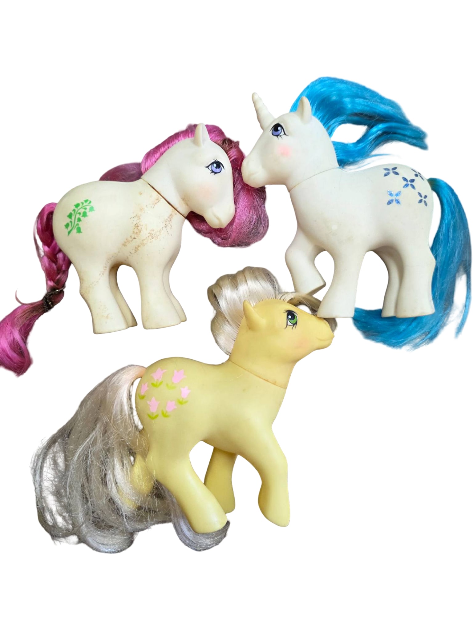 Three Vintage Hasbro My Little Pony Figures with Original Hair and Paint: Three vintage Hasbro My Little Pony figures featuring Majesty, Posey, and Birthflower Series May: Lily of the Valley. Each pony retains its original paint detailing and rooted hair in various colors (