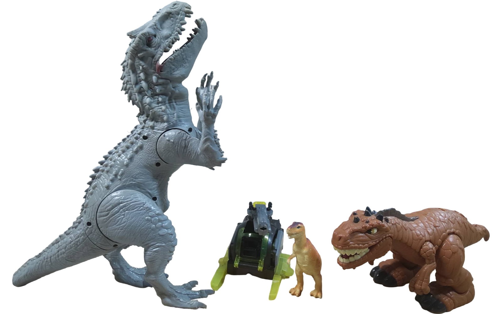 Dinosaur and Vehicle-Themed Toys, Including Movable Figures: Four dinosaur and vehicle-themed toys. The set includes a white dinosaur figure with articulated joints, a vehicle with a dinosaur head design and fluorescent accents, a small orange plastic dinosaur,