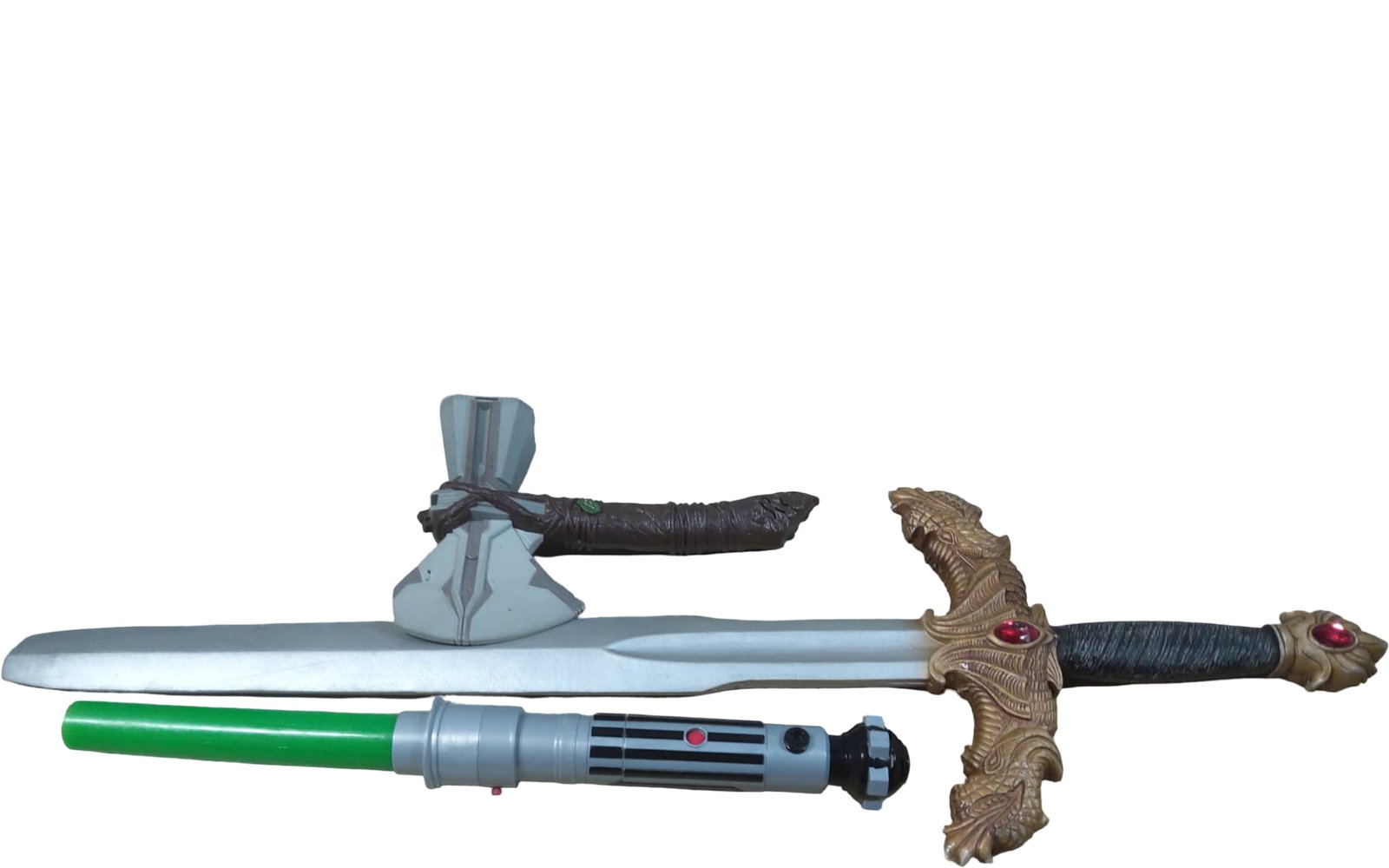 Toy Swords and Lightsaber Play Props: A lot comprised of three toy replica play weapons, including a plastic sword with a metallic silver blade and ornate dragon-themed hilt featuring red gem accents, a green plastic toy lightsaber with a