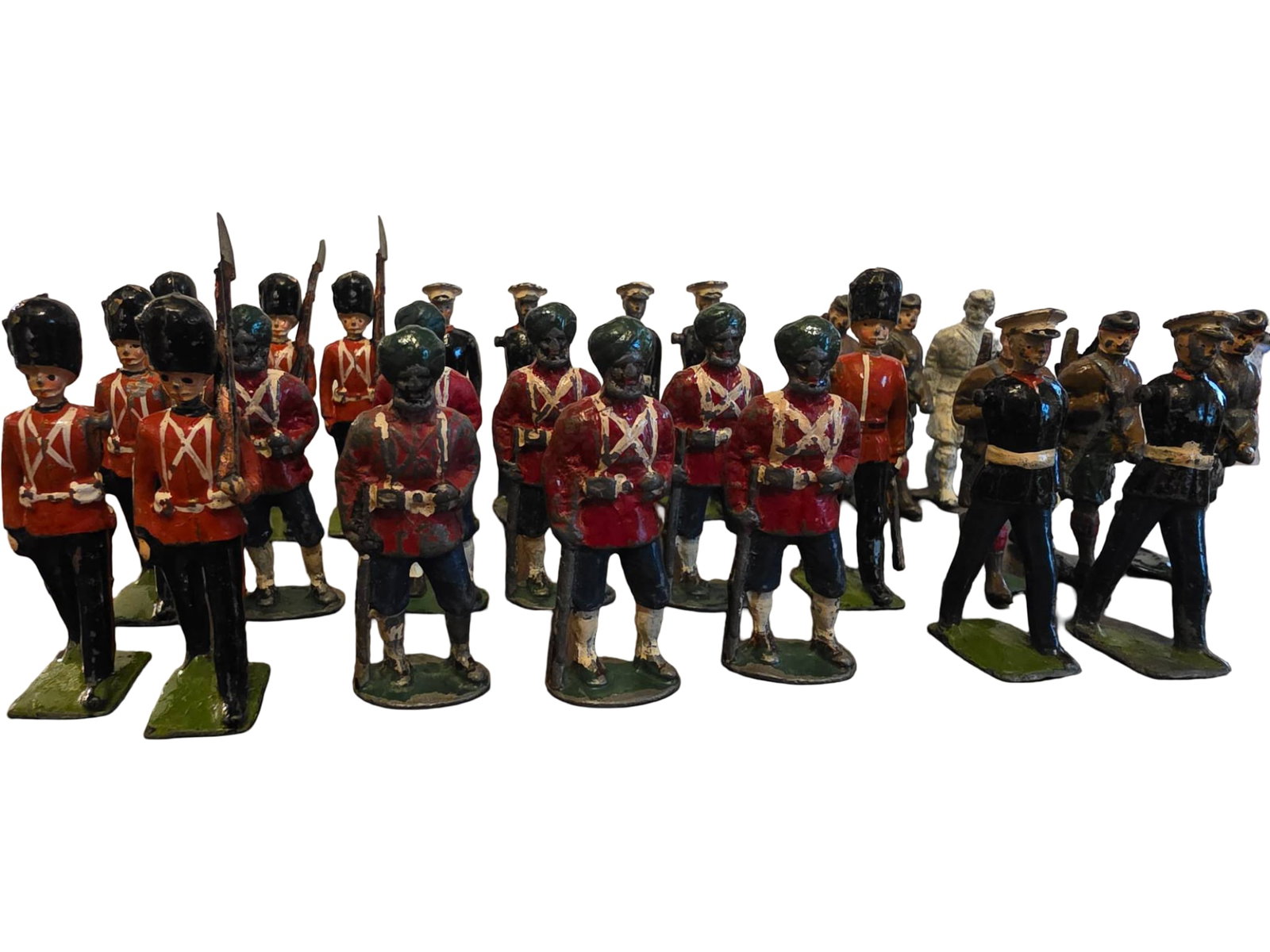 26 Painted Metal Soldiers and Military Figurines: 26 Cast metal figurines depicting soldiers and military personnel in various uniforms, including redcoats and black uniforms with distinct details such as swords and rifles. Some figurines exhibit sur
