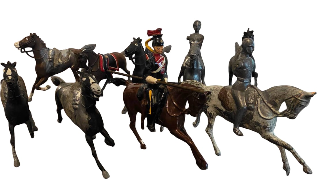 Nine Cast Metal Horse and Equestrian Figurines: 9 Cast metal horse and equestrian figurines, including rider on horseback, individual horses in various poses, and molded detailing on saddles and bridles. Paint and detailing visible, with wear and