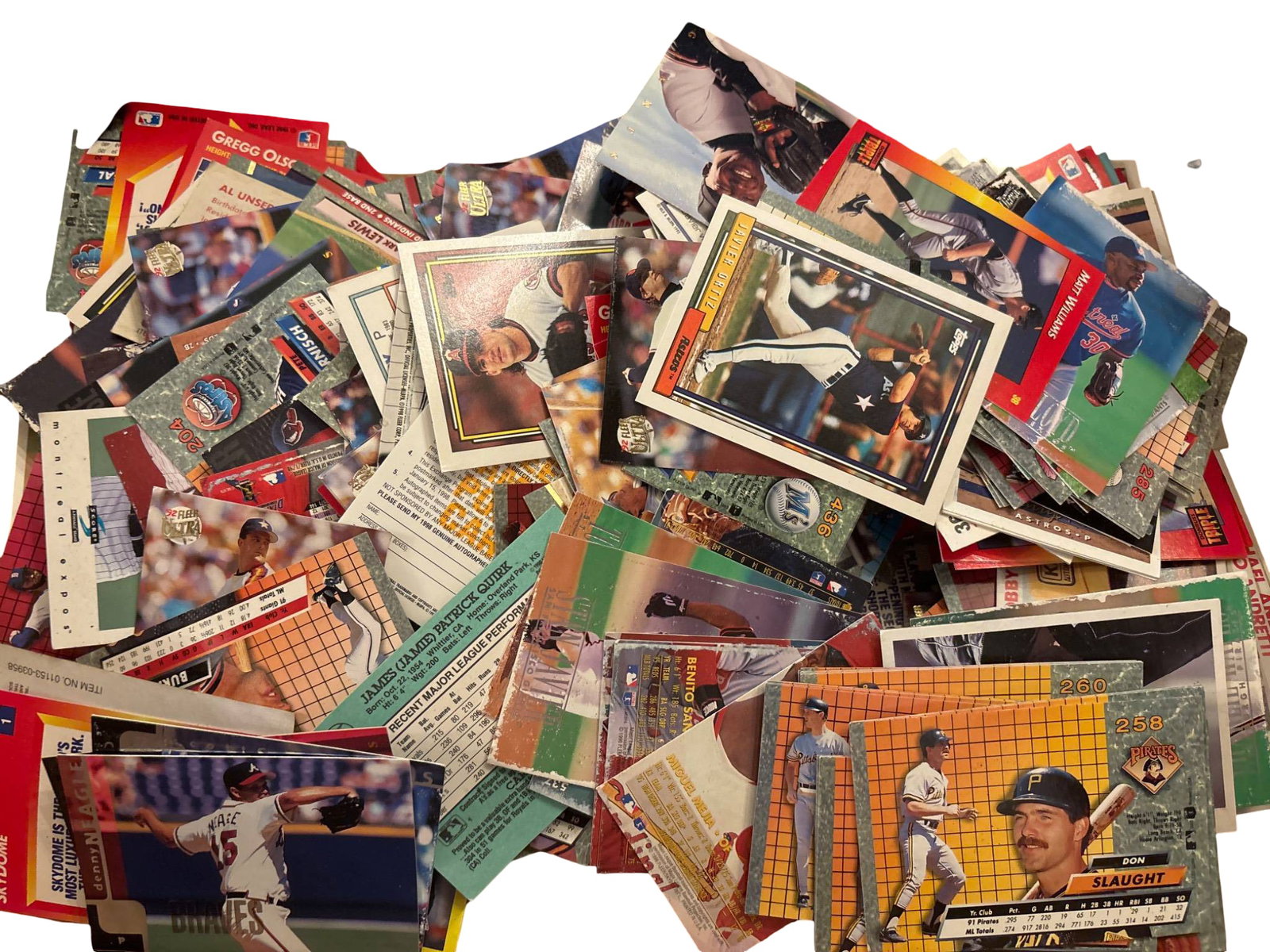 Baseball Trading Cards Collection: Baseball trading cards featuring various players, teams, and designs. Cards are of mixed conditions, consistent with handling and age. The collection includes potentially collectible items from