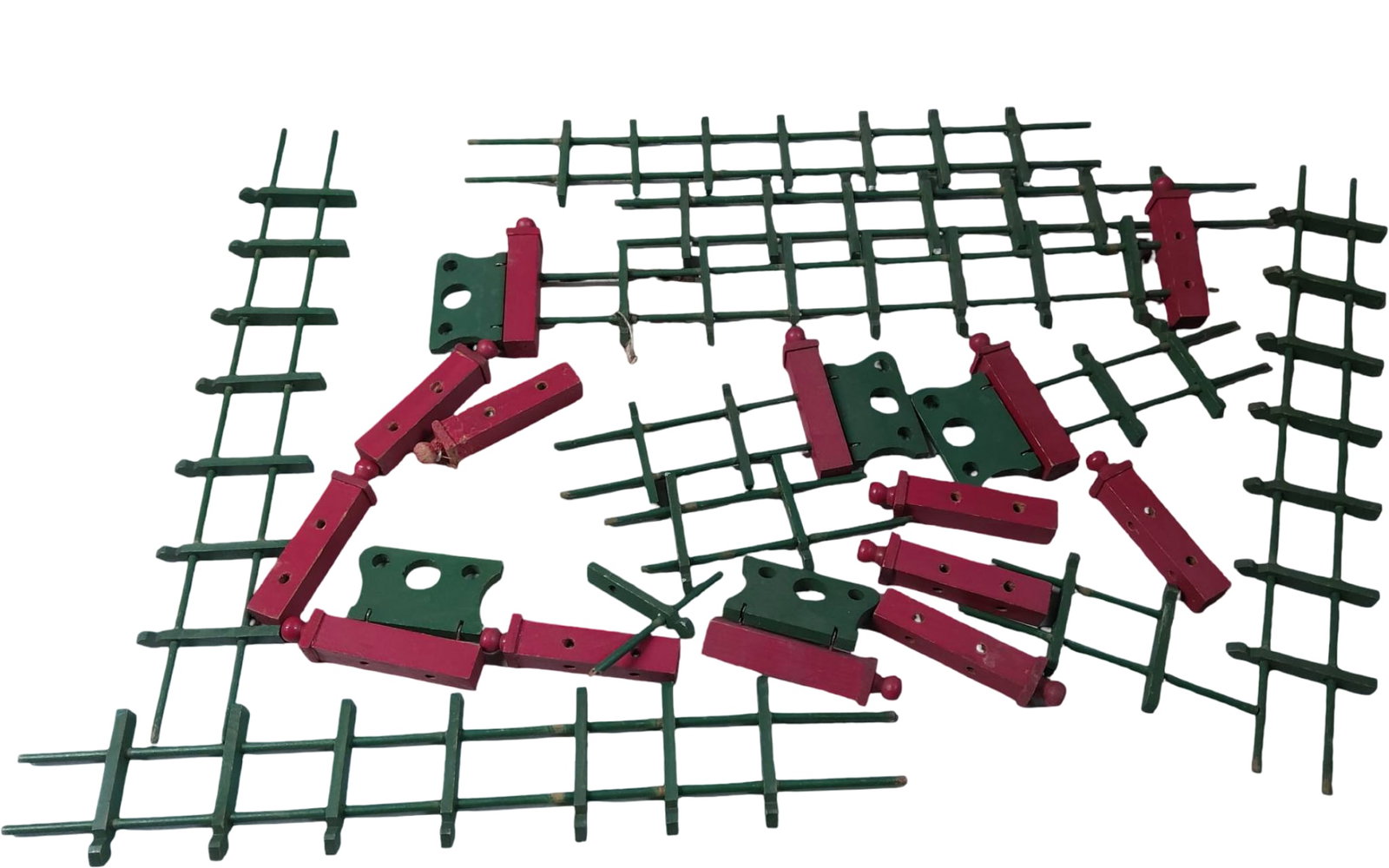 Wooden Toy Fence and Post Construction Set: A wooden construction set featuring green lattice-style fence panels and red posts with finial accents. Includes various components designed for assembly to create customizable structures. Scratches