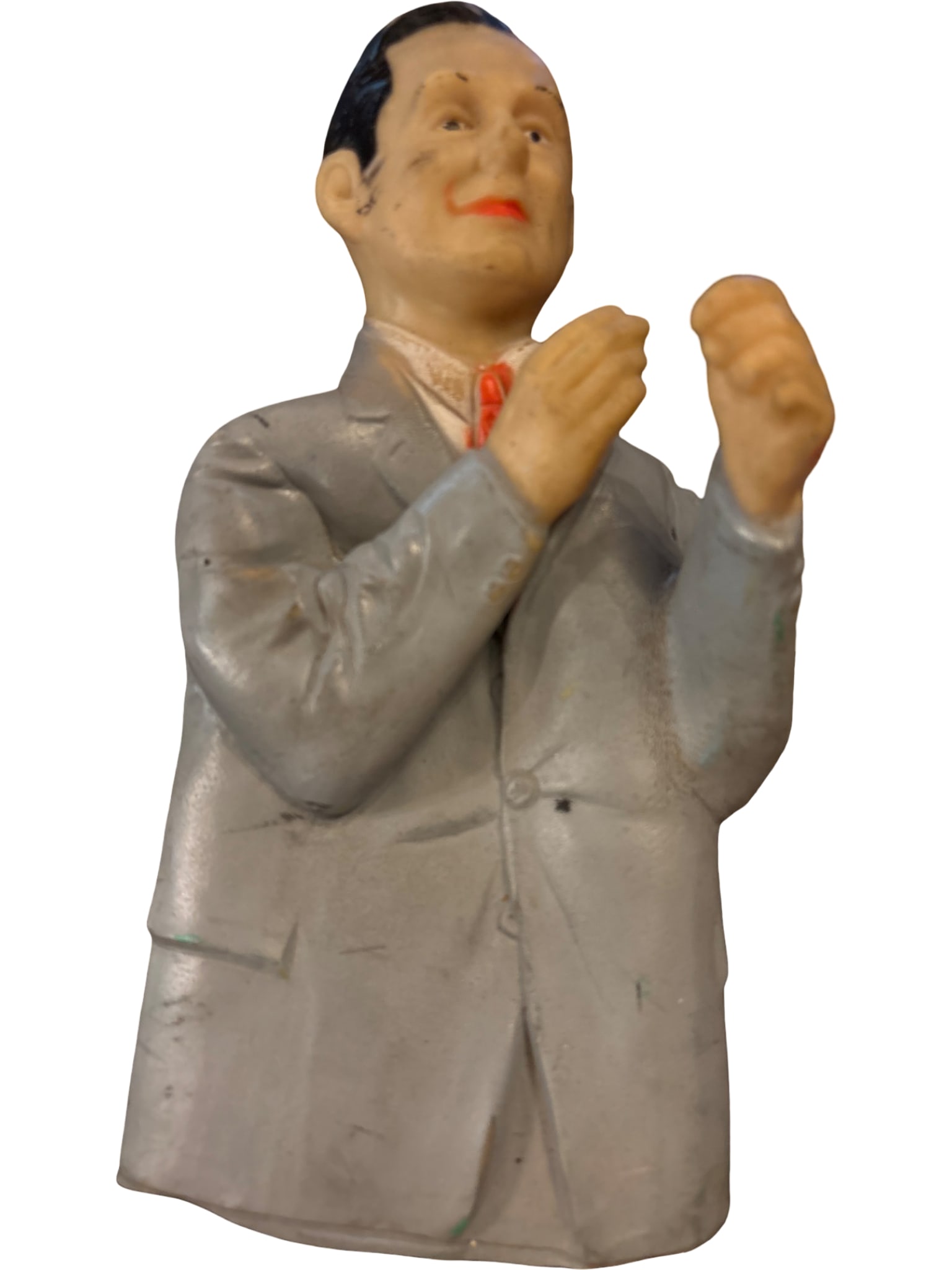 Hollow Rubber Figure of a Man in Gray Suit, Marked ‘Chi-craft’ and ‘Made in USA’: Hollow rubber figure depicting a man in a gray suit with a red tie, sculpted in a gesturing pose. Markings on the back read 'Chi-craft' and 'Made in U.S.A.' The figure shows minor surface wear,