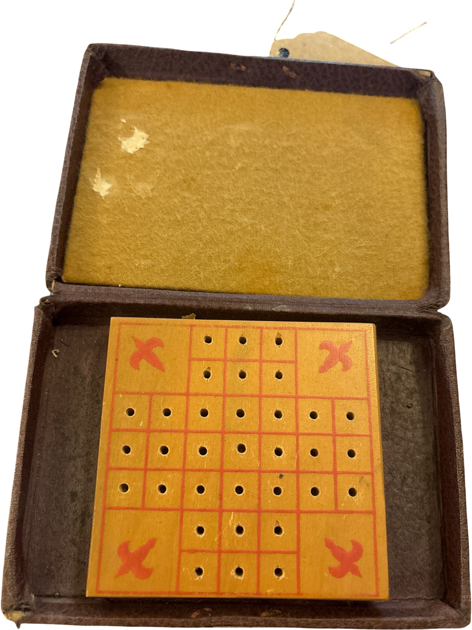 Vintage Wooden Peg Solitaire Game in Leatherette Box: Wooden peg solitaire game featuring a grid with drilled holes and red X markings on select squares. Housed in a leatherette-covered box with fabric-lined interior and a clasp closure. The game board
